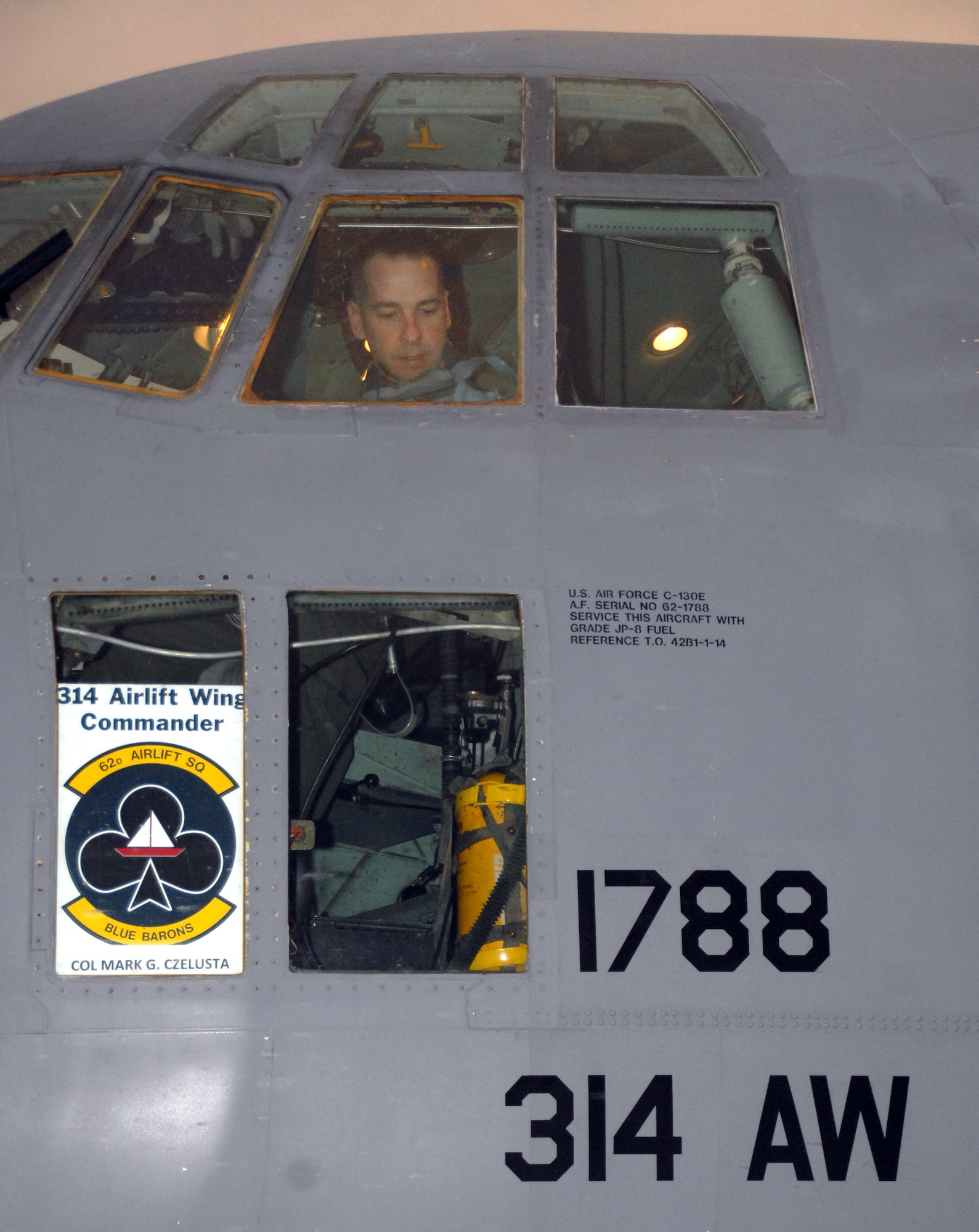 Col. Mark Czelusta, 314th Airlift Wing commander, performs pre-flight checks of Little Rock Air Force Base C-130E aircraft 62-1788 before its final flight, to Davis-Monthan Air Force Base's 309th Aerospace Maintenance and Regeneration Group in Arizona Nov. 29, 2010.  Aircraft 62-1788 was retired as part of a strategic Air Force effort to modernize its C-130 fleet with C-130J and C-130H AMP aircraft to meet the needs of today's warfighters in a more efficient, cost-effective way. Colonel Czelusta was the aircraft commander for the flight. (U.S. Air Force photo by Capt. Joe Knable)