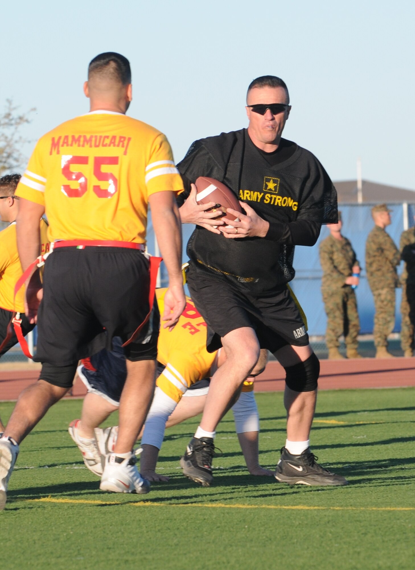 GOODFELLOW AIR FORCE BASE, Texas -- Army player Dan McGraw dodges Navy defender Robert Mammucari during the Army/Navy Flag Football Game Dec. 1.  The Army defeated the Navy during the annual challenge: 28-12.  (U.S. Air Force Photo/Airman 1st Class Clayton Lenhardt)