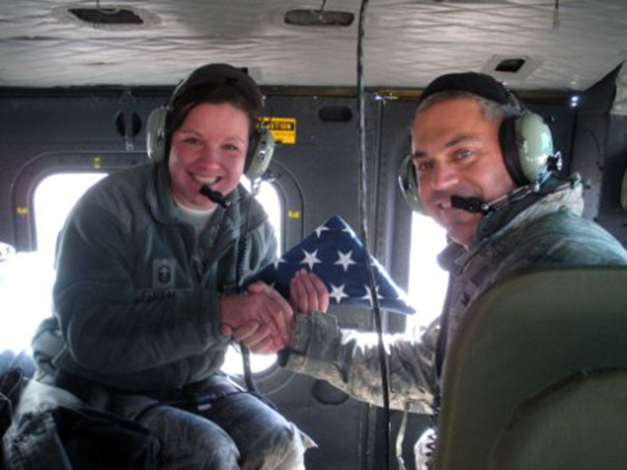 Master Sgt. Jessica Fehsal, 90th Maintenance Operations Squadron first sergeant, takes the oath of re-enlistment from Col. Robert Vercher, 90th Operations Group commander, aboard a UH-1N Bell Helicopter on Nov. 23. Master Sgt. Fehsal re-enlisted for four years after previously serving  for 12 years. (Courtesy photo)