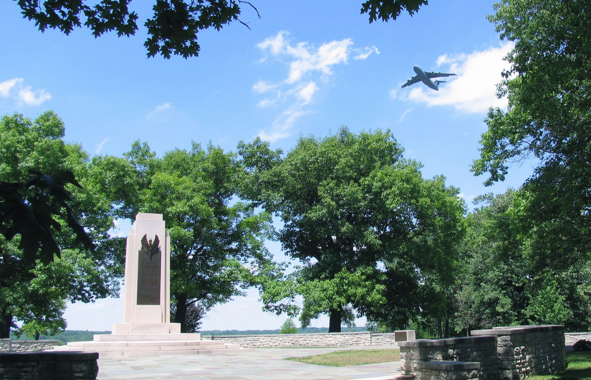 A C-5 Galaxy flies over the Wright Brothers Memorial, which overlooks the main runway at Wright-Patterson Air Force Base, Ohio. Dedicated in 1940, the memorial commemorates the contributions of Dayton inventors Orville and Wilbur Wright to manned powered flight. It is now part of the Dayton Aviation Heritage National Historic Park. Air Force and Park Service officials are planning a ceremony at the memorial Dec. 17, 2010 to celebrate the Wright's first successful powered flight. (Photo courtesy National Park Service) 