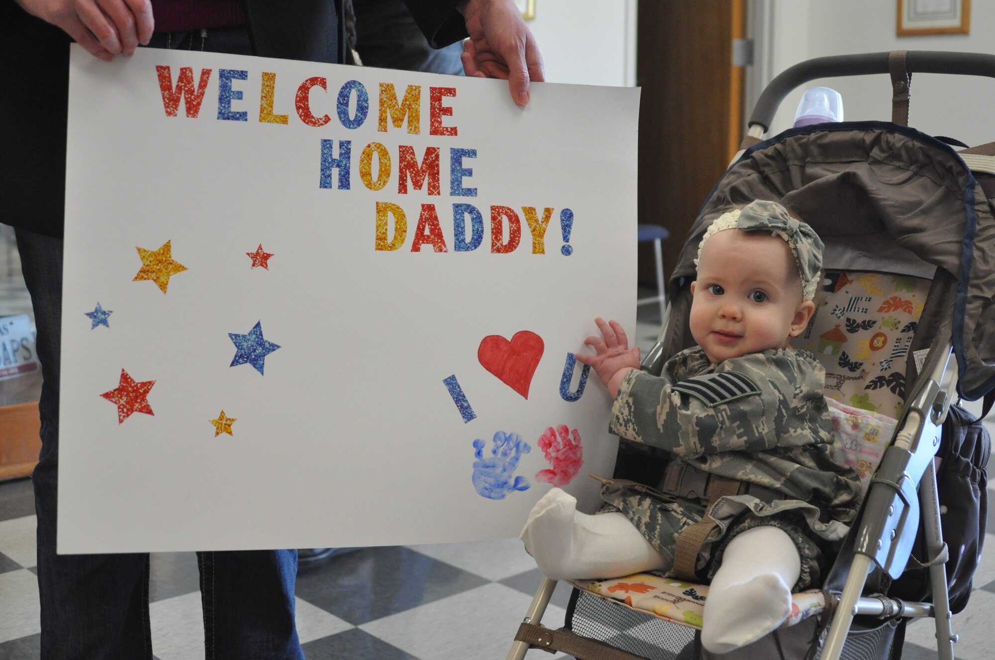 Addisyn Hall awaits the return of her father, TSgt. Todd Hall, a member of the 301st Fighter Wing Monday, December 6. Hall deployed to the Republic of Korea with over 70 other members of the 301st Fighter Wing. (U.S. Air Force photo/SrA Melissa Harvey)