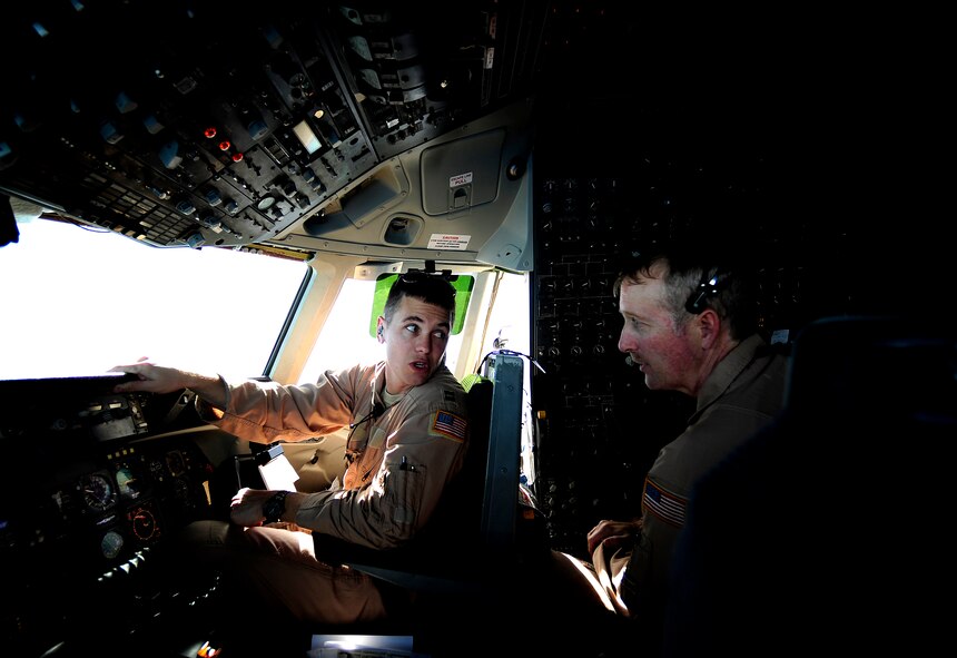 Capt. Wes Spurlock, left, a KC-10 Extender pilot with the 908th Expeditionary Air Refueling Squadron, talks with flight engineer Senior Master Sgt. John Aadland, right, at an undisclosed base in Southwest Asia on Nov. 25, 2010, during the start of a combat air refueling mission. As of Oct. 31, 2010, Airmen supporting the air refueling mission in the U.S. Central Command area of responsibility have off-loaded more than 880 million pounds of fuel to more than 69,000 aircraft for wartime operations in 2010, Air Forces Central statistics show. (U.S. Air Force Photo/Staff Sgt. Andy M. Kin)