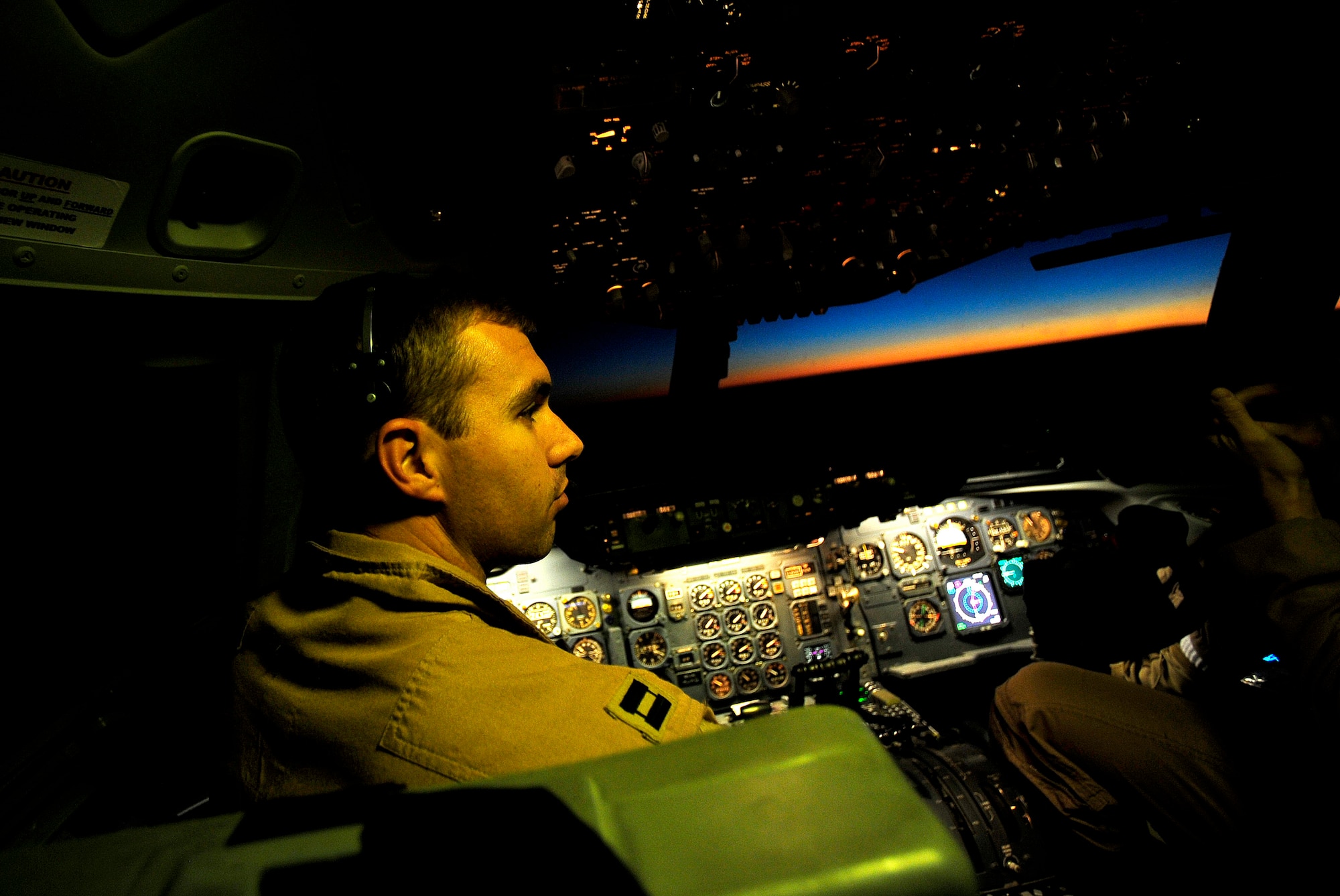 Capt. Nicholas Collins, a KC-10 Extender pilot deployed to the 908th Expeditionary Air Refueling Squadron, talks with crew members during an air refueling mission in support of Operation Enduring Freedom from an undisclosed location in Southwest Asia on Nov. 25, 2010. Captain Collins is deployed from the 9th Air Refueling Squadron, 60th Air Mobility Wing, at Travis Air Force Base, Calif. (U.S. Air Force Photo/Staff Sgt. Andy M. Kin)