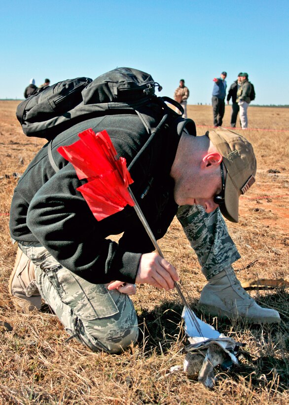 Tech. Sgt. James Fleming discovers a key piece of evidence during the investigation of a created crime scene Dec. 1, 2010, at Eglin Air Force Base, Fla. The investigations were part of the FBI's Large Vehicle Post-Blast School attended by state and local law enforcement agencies as well as Marine and Air Force explosive ordnance disposal technicians. Sergeant Flemings is a 1st Special Operations Civil Engineer Squadron EOD technician. (U.S. Air Force photo/ 2nd Lt. Andrew Caulk)