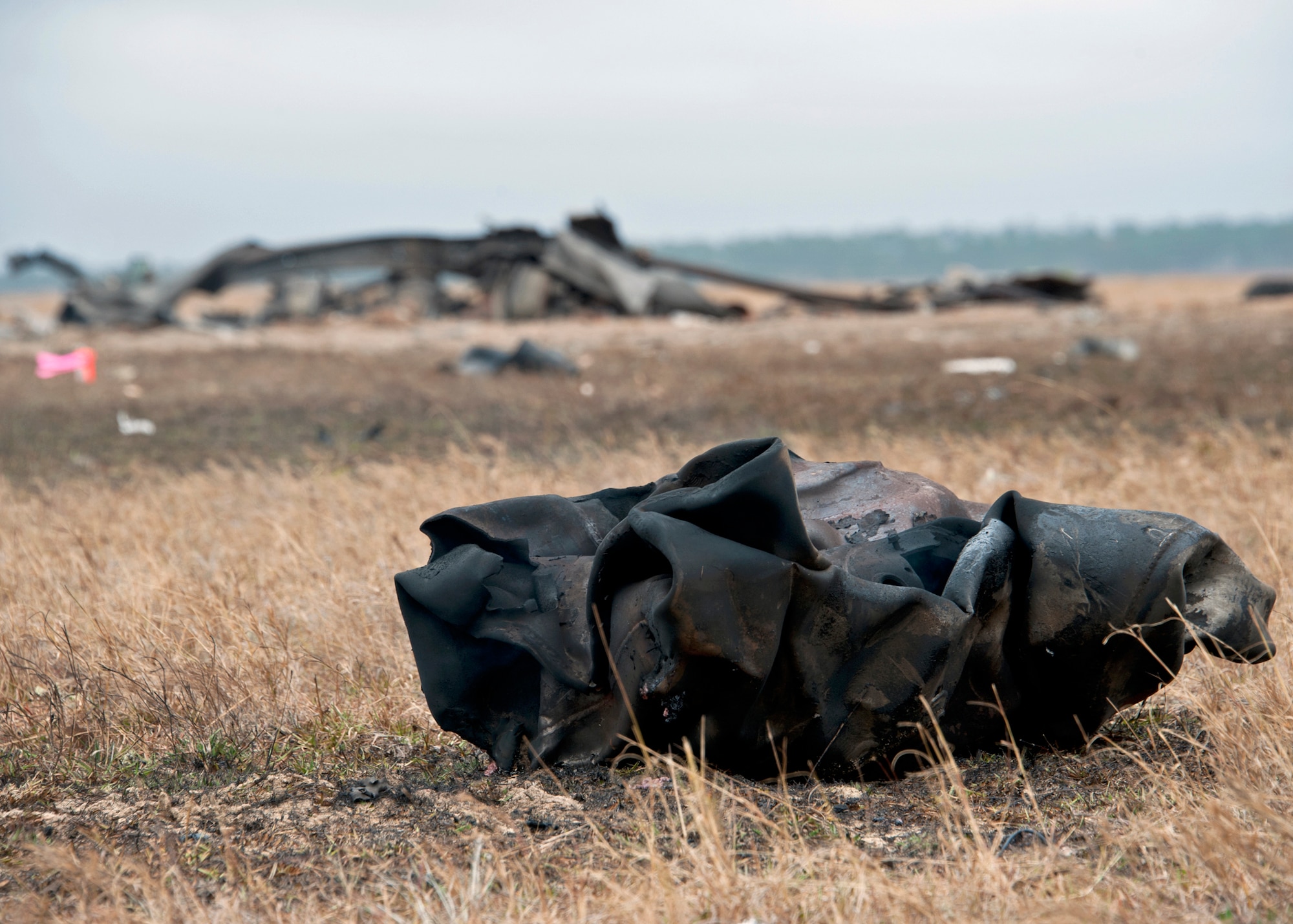 A charred piece of metal from the engine of a box truck was blasted away from the vehicle when it was detonated on the range Nov. 30, 2010, at Eglin Air Force Base, Fla. The detonation created a simulated crime scene for the FBI's Large Vehicle Post-Blast School. State and local law enforcement agencies, as well as Marine and Air Force explosive ordnance disposal technicians, attended the week-long class. (U.S. Air Force photo/Samuel King)