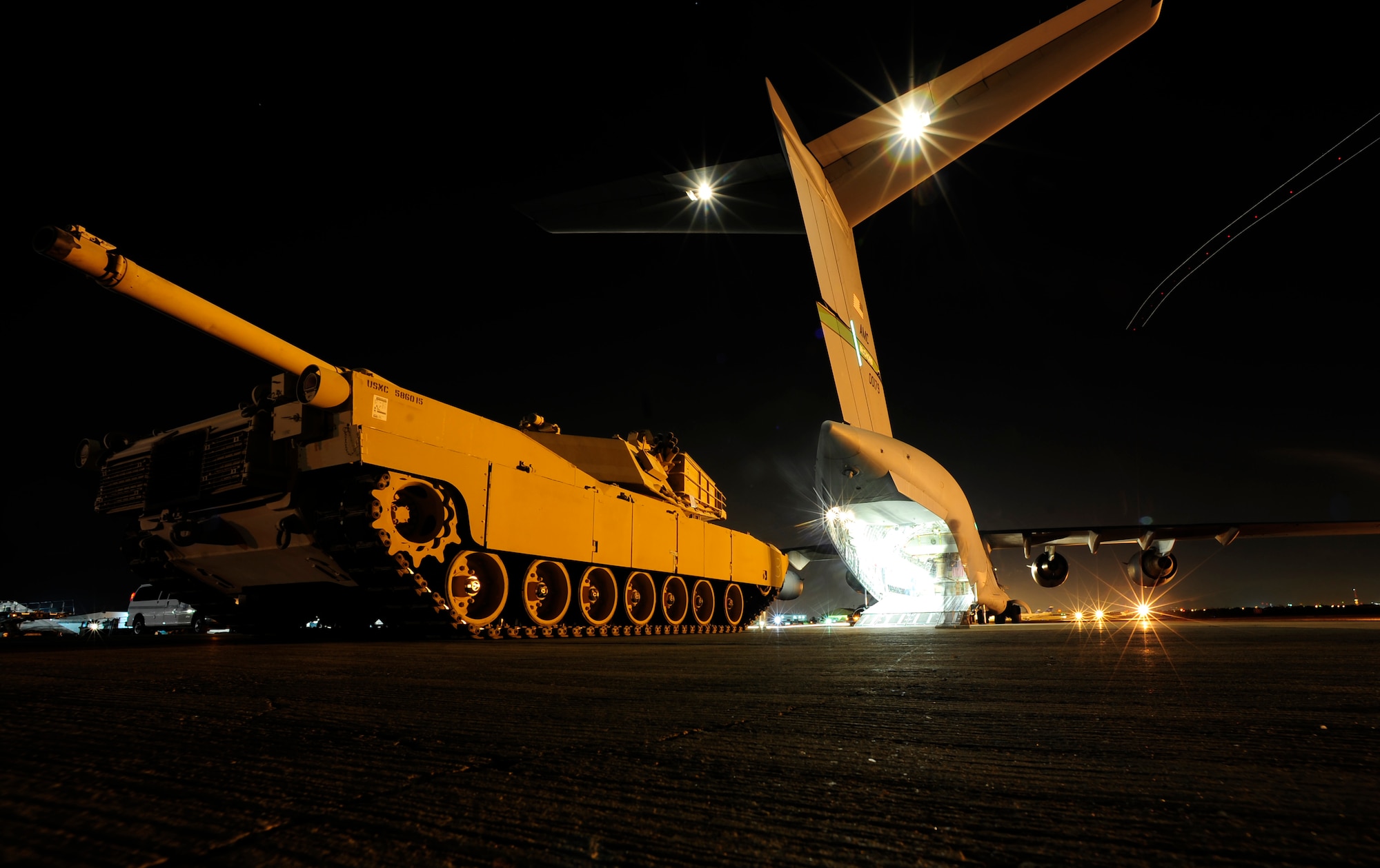 A U.S. Marine Corps M1A1 Abrams tank sits on a flightline prior to being loaded on to an Air Force C-17 Globemaster III aircraft assigned to the 816th Expeditionary Airlift Squadron (EAS) en route to Afghanistan in support of Operation Enduring Freedom on Nov. 28, 2010. The 816th EAS is an airlift unit assigned to an undisclosed location in Southwest Asia. (U.S. Air Force Photo/Staff Sgt. Andy M. Kin)