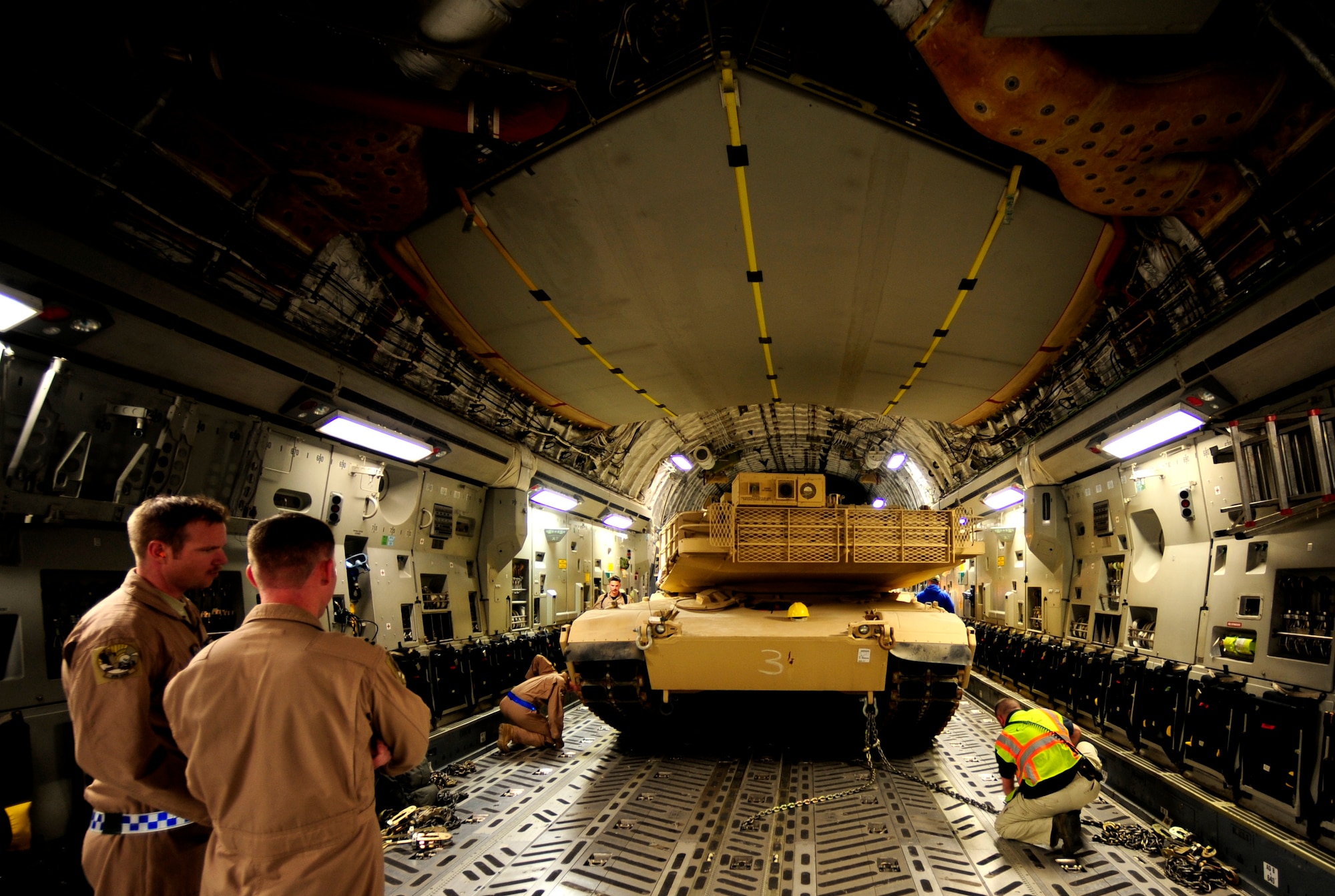 A C-17 Globemaster III aircraft crew assigned to the 816th Expeditionary Airlift Squadron (EAS) loads a Marine Corps M1A1 Abrams tank for aerial transport to Afghanistan in support of Operation Enduring Freedom on Nov. 28, 2010. The 816th EAS is an airlift unit assigned to an undisclosed location in Southwest Asia. (U.S. Air Force Photo/Staff Sgt. Andy M. Kin)