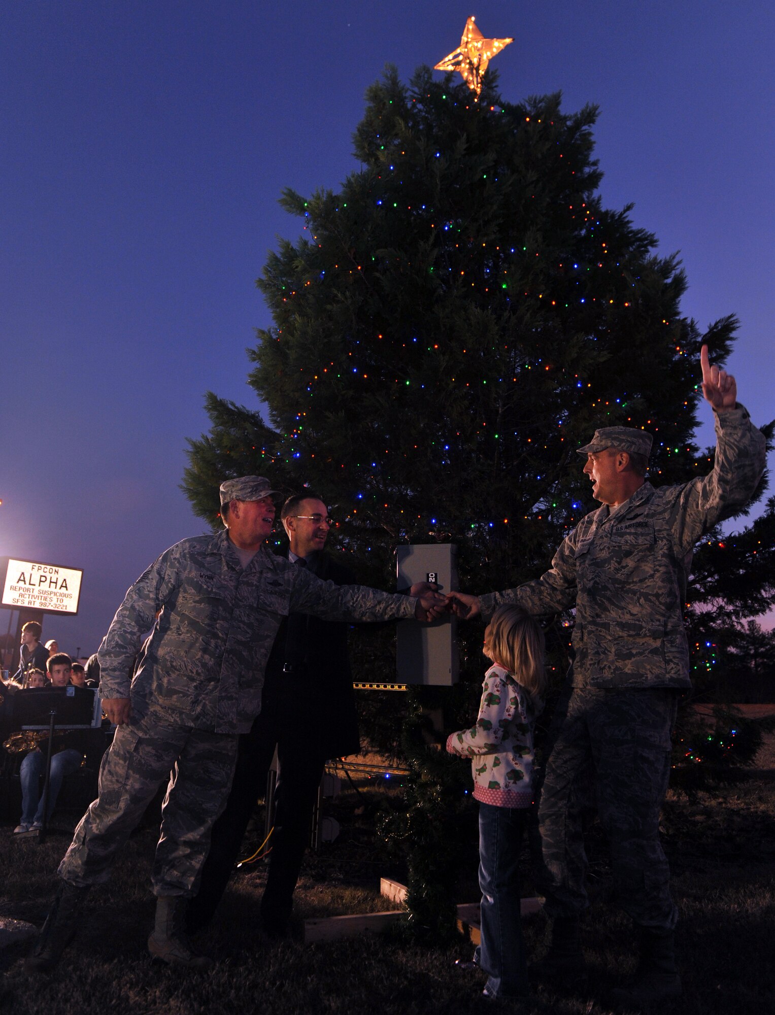 (From right) Col. Mike Minihan, 19th Airlift Wing commander, with his daughter, Marley, Col. Mark Czelusta, 314th Airlift Wing commander, and Chief Master Sgt Gary Wynn, 189th Airlift Wing command chief, flip the power switch to light up the base’s three Christmas trees Dec. 3, 2010, at Little Rock Air Force Base, Ark.  Spectators enjoyed the tree lighting with music, followed by a visit from Santa and cookies and hot cocoa at the chapel. (U.S. Air Force photo by Senior Airman Gul Crockett)