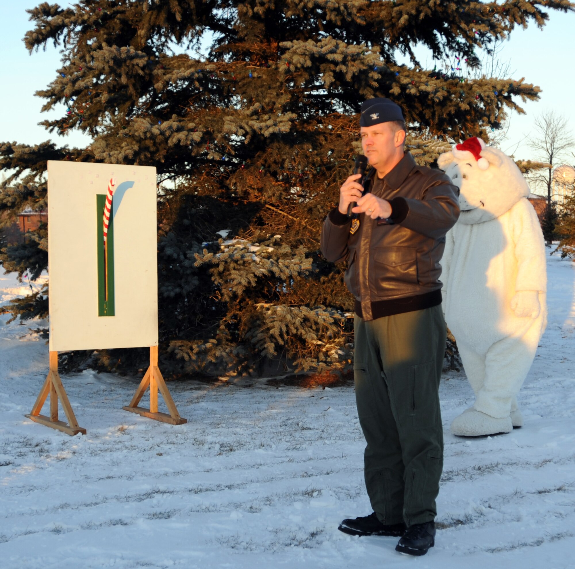 Col. Don Shaffer, 319th Air Refueling Wing commander, addresses Airmen and their families before the official lighting of the holiday tree during the annual holiday tree lighting ceremony Dec. 1 outside of the base fitness center. (U.S. Air Force photo by Staff Sgt. Suellyn Nuckolls)