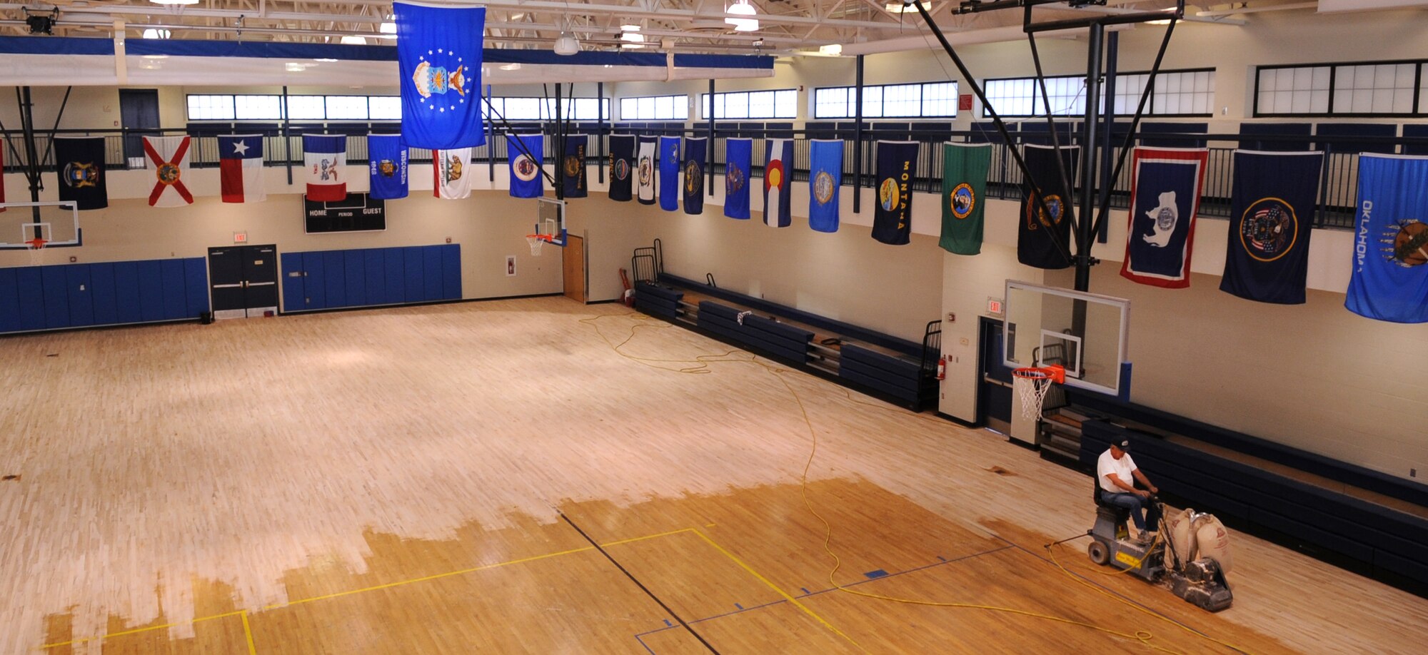 MOODY AIR FORCE BASE, Ga. -- Andy Reid, contracted worker, uses a riding sander at the Freedom I Fitness Center Dec. 2. It is necessary to strip and rewax the basketball court floor every four years. (U.S. Air Force Photo/Airman 1st Class Douglas Ellis)(RELEASED)