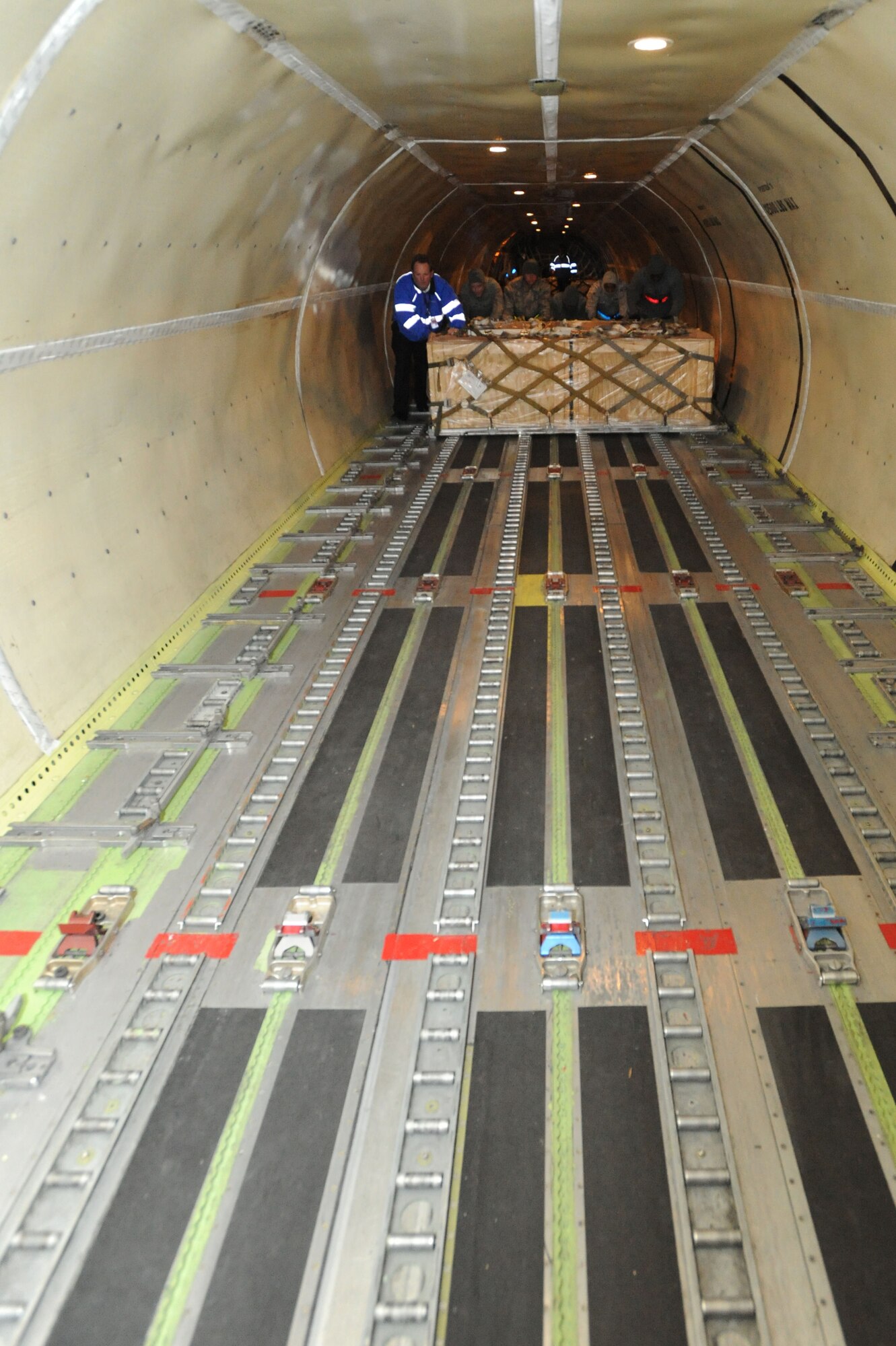 WHITEMAN AIR FORCE BASE, Mo. - Airmen of the 509th Logistics Readiness Squadron push pallets of Los Angeles class submarine batteries to the back of a DC-8 cargo aircraft, Dec. 4. The loading process ran about 2 hours after the aircraft landed here. (U.S. Air Force photo by Senior Airman Carlin Leslie)(Released)

