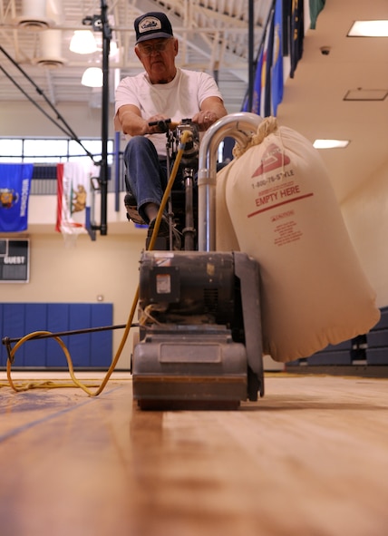 MOODY AIR FORCE BASE, Ga.-- Andy Reid, contracted worker, uses a riding sander to remove the wax from the Freedom I Fitness Center’s gym floor Dec. 1. It will take approximately one week of sanding before the floor will be prepared for sealer and paint. (U.S. Air Force photo/Airman 1st Class Benjamin Wiseman)(RELEASED)