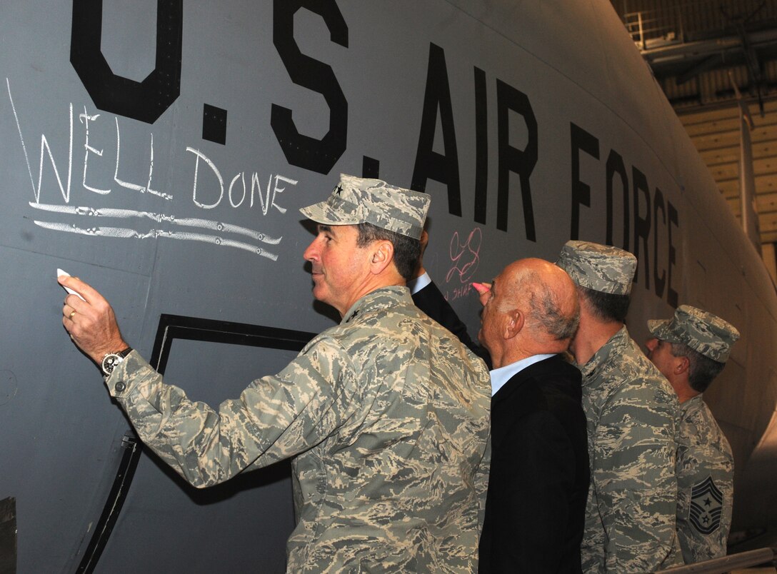 Gen. Raymond Johns (from left), John Marshall, Col. Don Shaffer and Chief Master Sgt. David Spector sign the last KC-135 Stratotanker stationed at Grand Forks Air Force Base, Dec. 3, 2010, after the conclusion of the mission-complete ceremony. The ceremony was held to recognize the completion of 50 years of Stratotanker flight and maintenance operations on base. Grand Forks AFB is scheduled to receive RQ-4 Global Hawks in the summer of 2011. General Johns is the Air Mobility Command commander. Mr. Marshall is the Grand Forks Air Force Base ambassador. Colonel Shaffer is the 319th Air Refueling Wing commander and Chief Spector is the AMC command chief. (U.S. Air Force photo/Tech. Sgt. Johnny Saldivar)