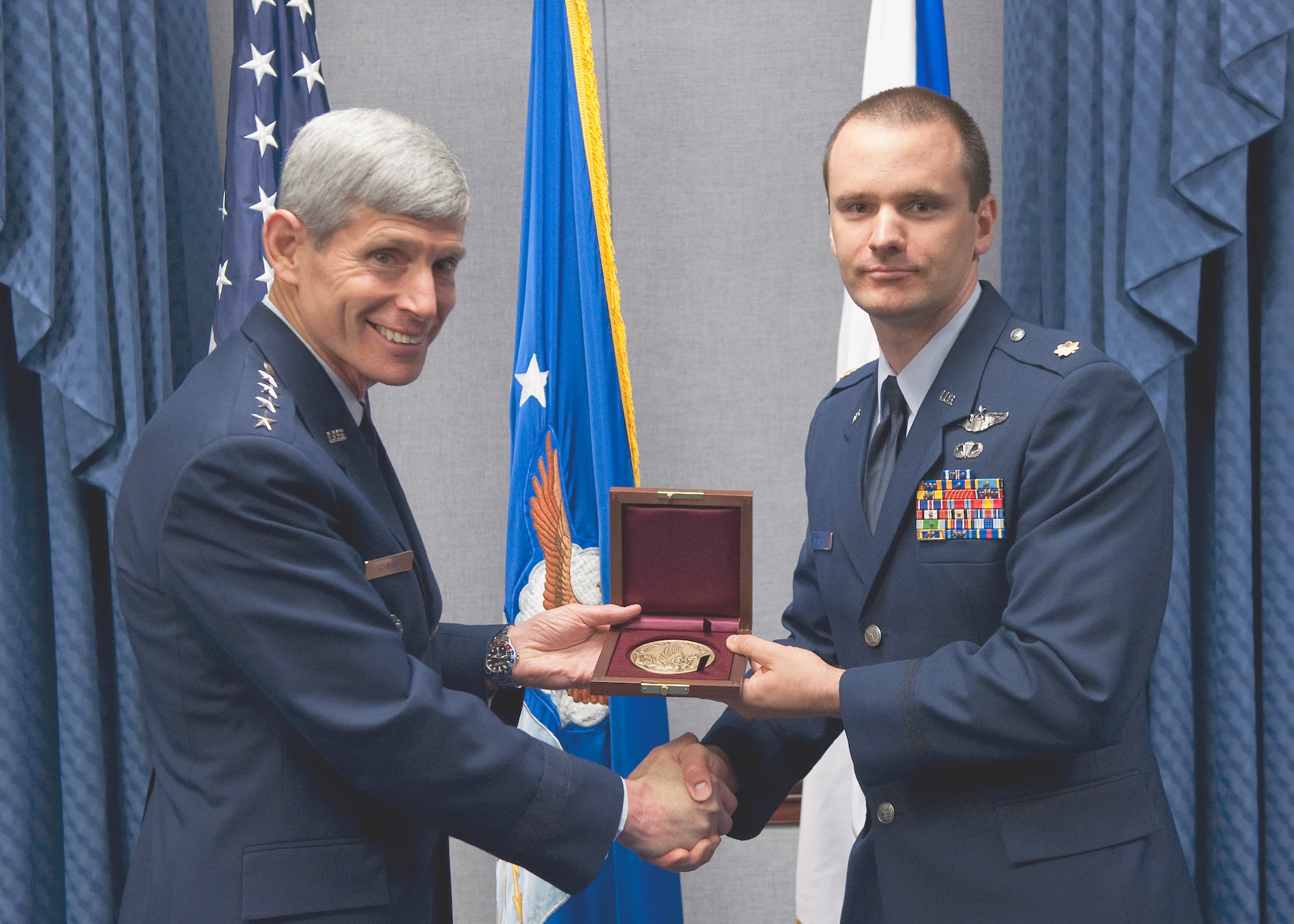 Air Force Chief of Staff Gen. Norton Schwartz presents Maj. John G. Mangan with the Cheney Award Oct. 15, 2010, at the Pentagon. Major Mangan received the award for his actions as the pilot of an HH-60 Pave Hawk on a rescue mission in Helmland Valley, Afghanistan.  Without ground communications or airborne support, Major Mangan managed to land and save the lives of two critically injured Marines under intense enemy fire. The Cheney Award is presented each year to aviators who demonstrate an act of valor, extreme fortitude or self-sacrifice in a humanitarian venture. Established in 1927, the award is in memory of 1st Lt. William Cheney, who was killed in an air collision over Italy in 1918. Major Mangan is currently assigned to Nellis Air Force Base, Nev. (U.S. Air Force photo/Jim Varhegyi) 