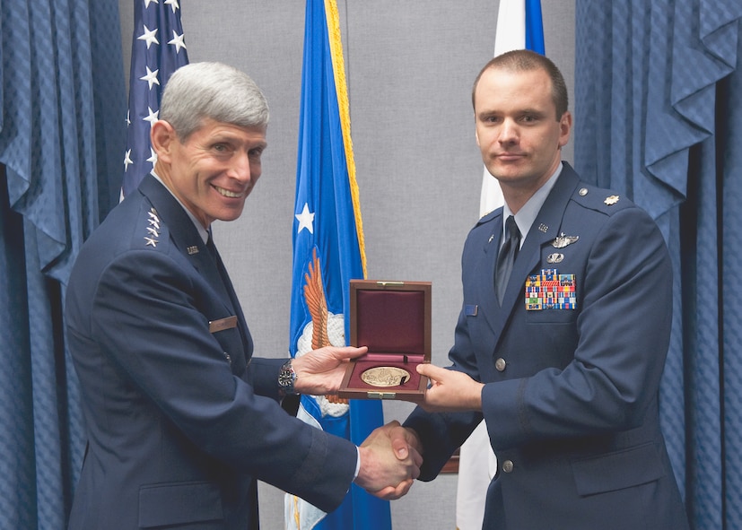 Air Force Chief of Staff Gen. Norton Schwartz presents Maj. John G. Mangan with the Cheney Award Oct. 15, 2010, at the Pentagon. Major Mangan received the award for his actions as the pilot of an HH-60 Pave Hawk on a rescue mission in Helmland Valley, Afghanistan.  Without ground communications or airborne support, Major Mangan managed to land and save the lives of two critically injured Marines under intense enemy fire. The Cheney Award is presented each year to aviators who demonstrate an act of valor, extreme fortitude or self-sacrifice in a humanitarian venture. Established in 1927, the award is in memory of 1st Lt. William Cheney, who was killed in an air collision over Italy in 1918. Major Mangan is currently assigned to Nellis Air Force Base, Nev. (U.S. Air Force photo/Jim Varhegyi) 