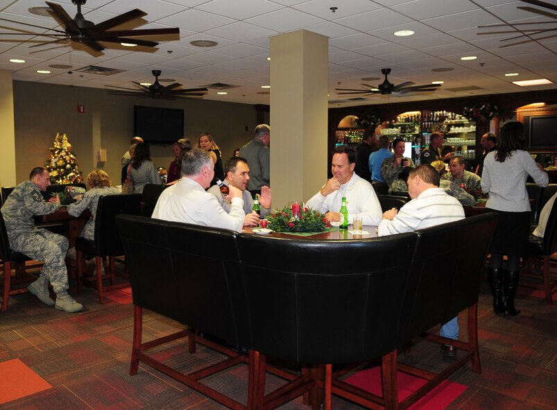 MOODY AIR FORCE BASE, Ga. -- Members from the 23rd Wing enjoy the new Officer's Lounge Dec. 3. Drinks and hors d'oeuvres were provided by the Moody Field Club to celebrate two months of renovations to the lounge. (U.S. Air Force photo/Senior Airman Stephanie Mancha)(RELEASED)