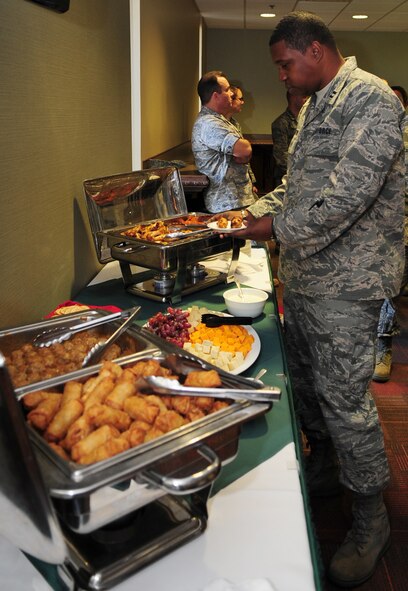 MOODY AIR FORCE BASE, Ga. -- Capt. Brandon Preston, 23rd Maintenance Operations Squadron operations officer, enjoys hors d'oeuvres Dec. 3. The Moody Field Club provided hors d'oeuvres for the Officer's Lounge opening. (U.S. Air Force photo/Senior Airman Stephanie Mancha)(RELEASED)