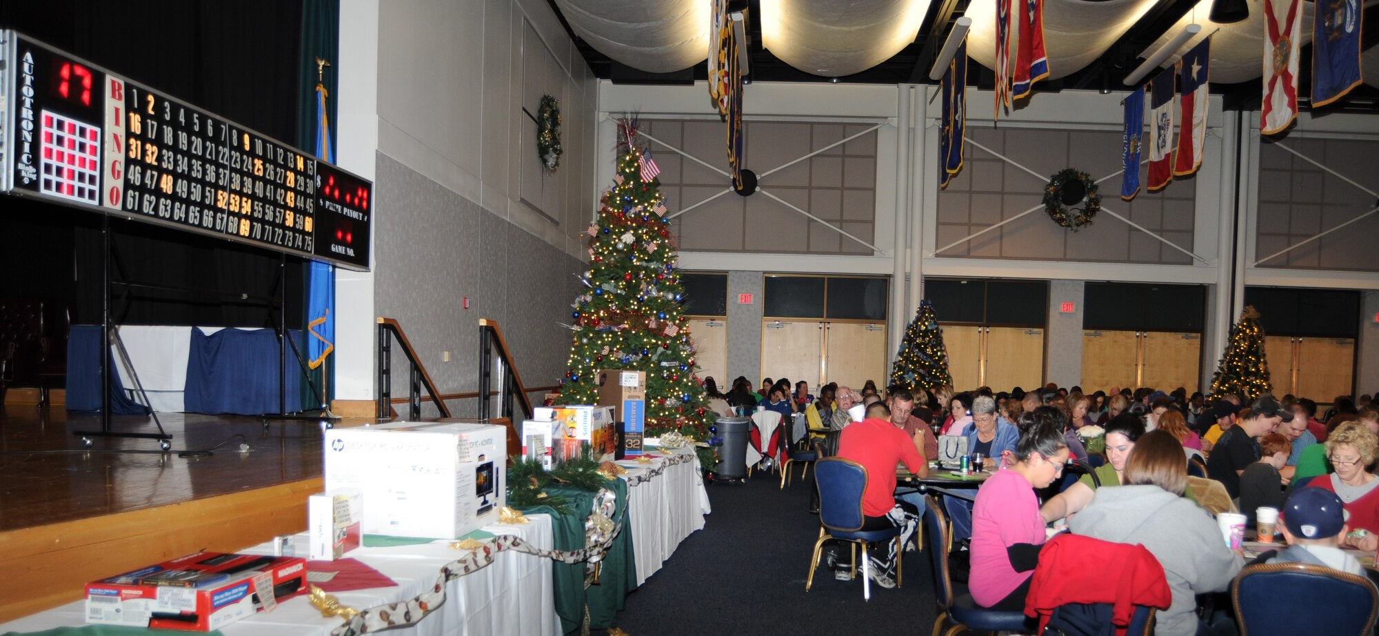 Team McConnell Airmen and family members play electronic Bingo at the Robert J. Dole Community Center Dec. 12, 2010, McConnell Air Force Base, Kan. The 22nd Force Support Squadron sponsored-event provided members with an evening of holiday entertainment. More than 363 participants attended Bingo night for a chance to win electronic prizes, such as MP3 player, printer, desktop computer, and gaming consoles.  (U.S. Air Force photo/Senior Airman Maria A. Ruiz)  