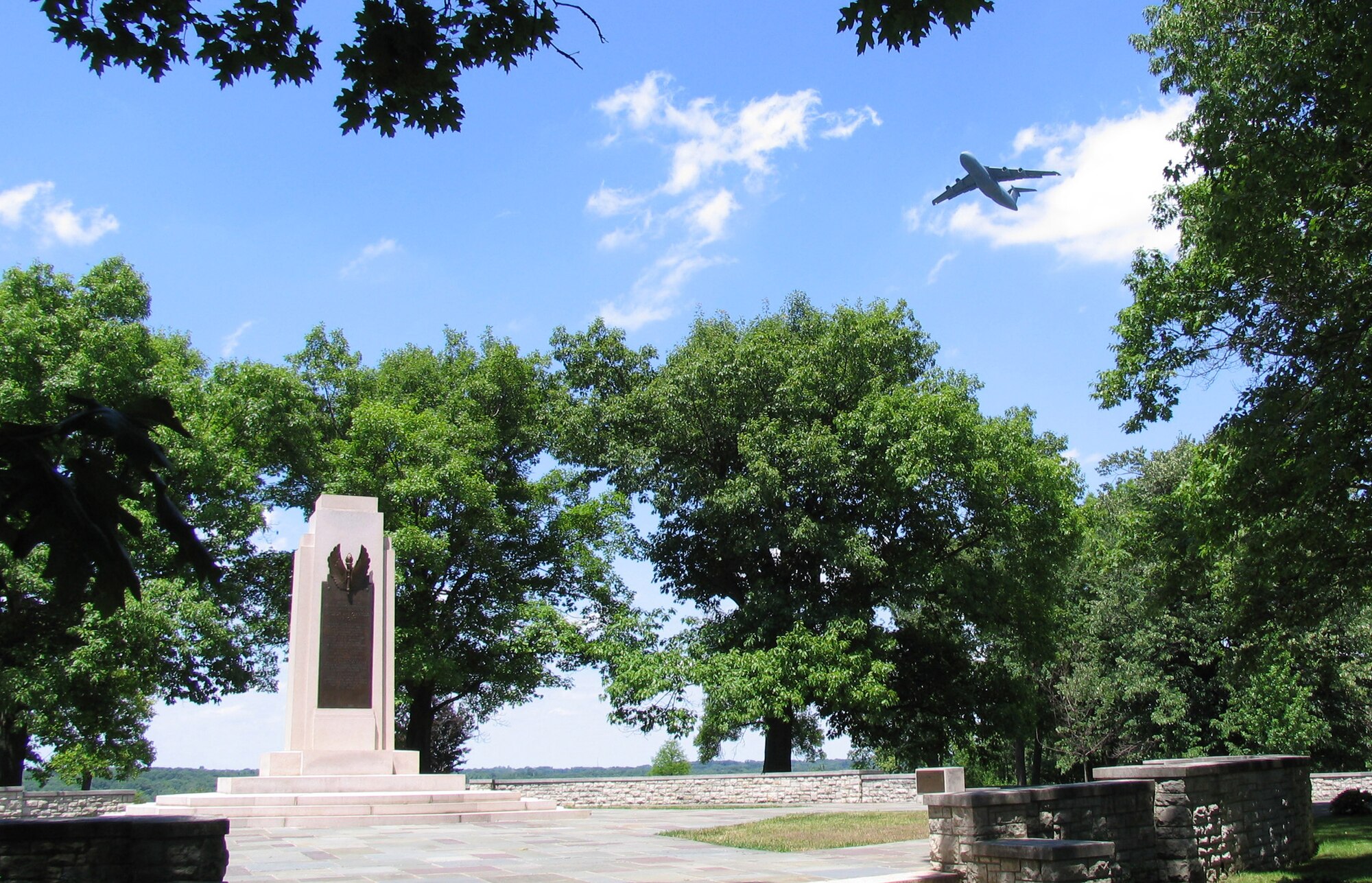 A C-5 Galaxy overflys the Wright Brothers Memorial which overlooks the main runway at Wright-Patterson Air Force Base, Ohio.  Dedicated in 1940, the memorial commemorates Dayton inventors Orville and Wilbur Wright and their contributions to manned powered flight. It is now part of the Dayton Aviation Heritage National Historic Park. (Photo courtesy National Park Service)