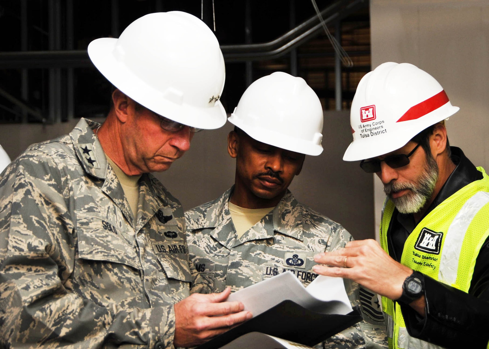 ALTUS AIR FORCE BASE, Okla. -- Maj. Gen. Mark S. Solo, 19th Air Force commander, Chief Master Sgt. Michael M. Williams, 19th AF command chief, and Keith Maxwell, U.S. Army Corps of Engineers resident engineer, review plans for a new Radar Approach Control building here Dec. 1. General Solo and Chief Williams visited units across the Mighty 97th Dec. 1-3. (U.S. Air Force photo by Airman 1st Class Myles Stepp / 97th Air Mobility Wing Public Affairs)
