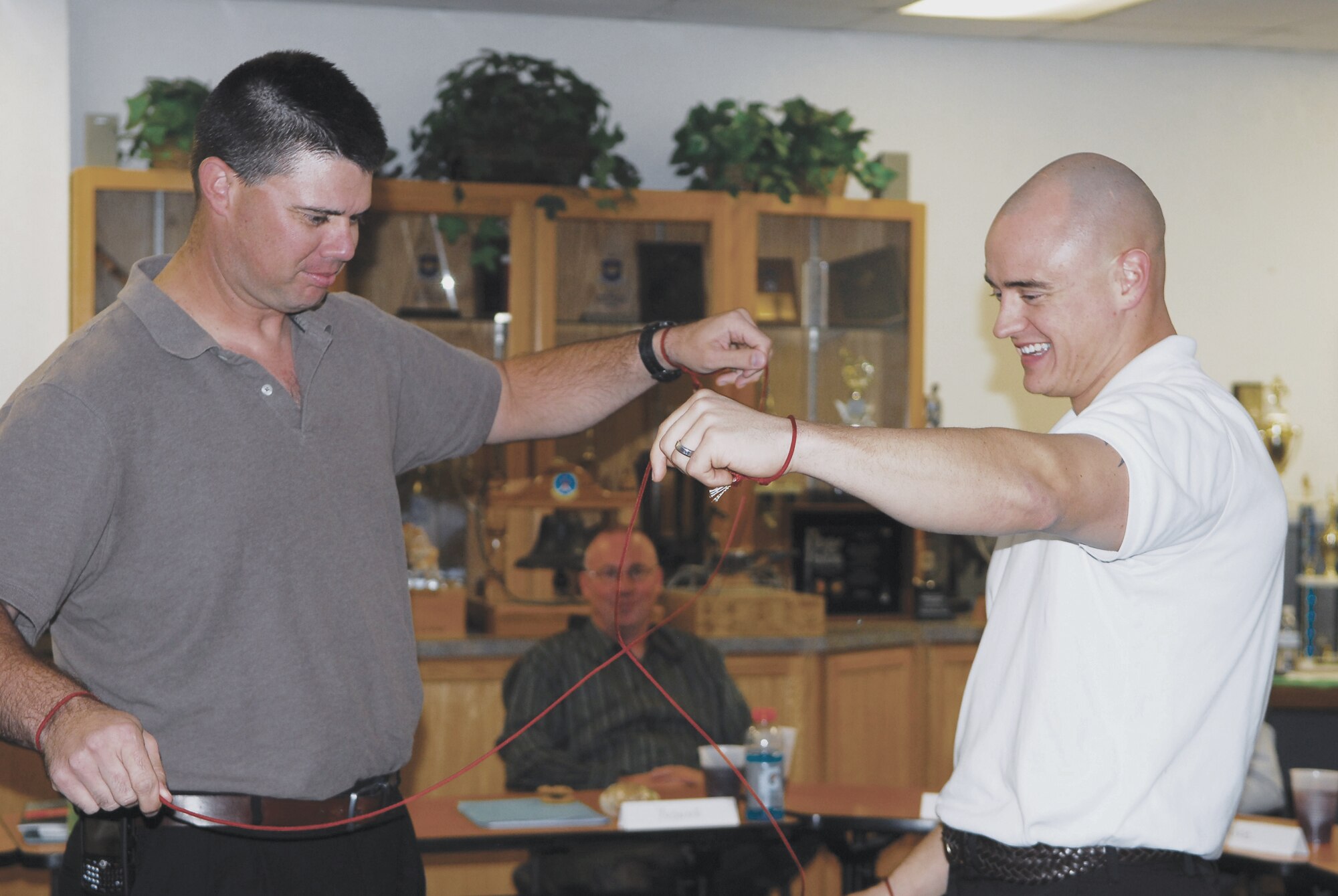 Tech. Sgt. David Daggett and Staff Sgt. Christian Nichols, attempt to solve a puzzle at a leadership seminar on November 18th.  (U.S. Air Force photo/Airman 1st Class Melanie Holochwost)