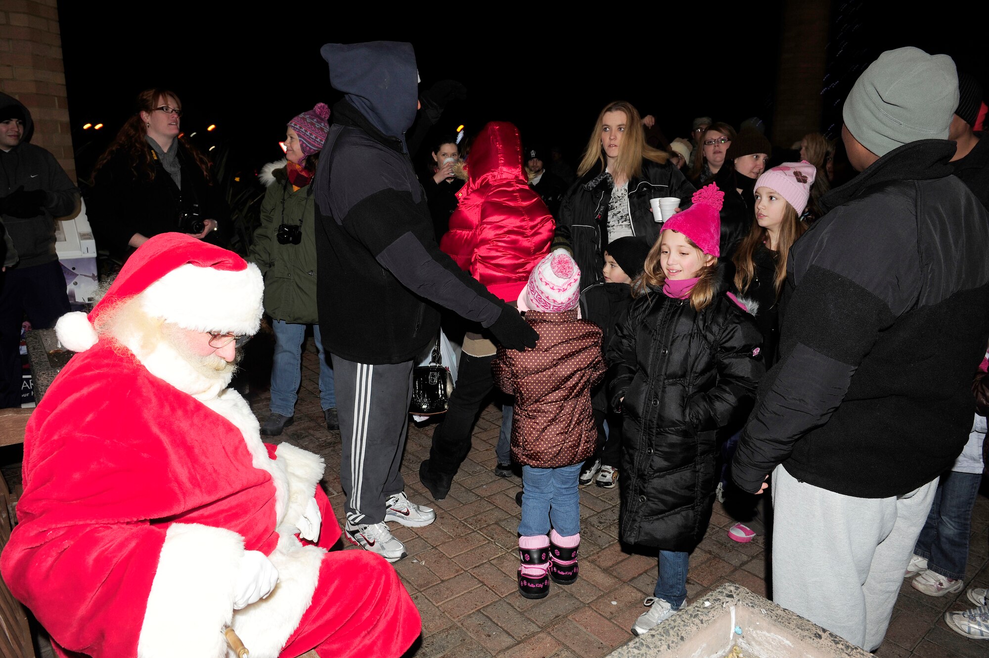 ROYAL AIR FORCE LAKENHEATH, England -- Children line up to see Santa Claus during his surprise visit to the annual Christmas tree lighting ceremony Dec. 3. The ceremony signified the start of the Christmas season. (U.S. Air Force photo/Airman 1st Class Tiffany M. Deuel)