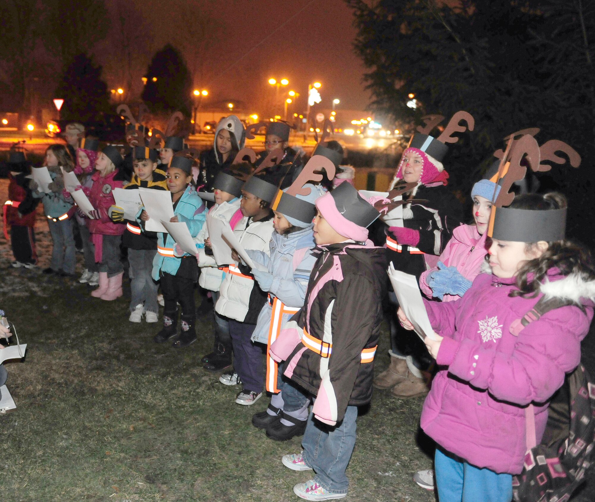 ROYAL AIR FORCE LAKENHEATH, England -- Children enrolled in Lakenheath’s youth program sing Christmas carols at the annual Christmas tree lighting ceremony Dec. 3. The event, presided over by 48th Fighter Wing Commander Col. John Quintas, kicked off the holiday season for Lakenheath. (U.S. Air Force photo/Airman 1st Class Tiffany M. Deuel)