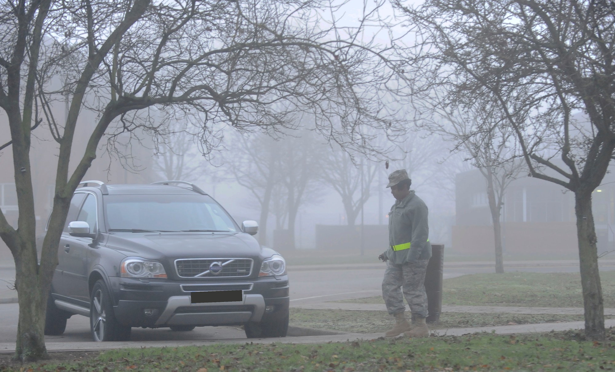 RAF MILDENHALL, England -- An Airman from RAF Mildenhall walks to their car through a dense layer of fog while wearing a reflective belt Dec. 6, 2010. Air Force guidance states reflective belts or clothing must be worn by anyone in uniform during periods of reduced visibility so as to increase the wearer's safety. (U.S. Air Force photo/Senior Airman Ethan Morgan)