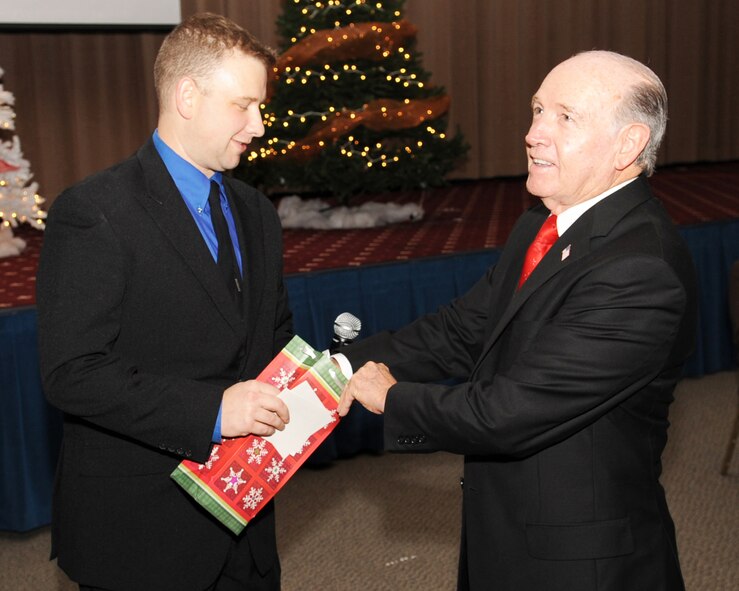 Lorenz Walker (right), mayor of Bossier City, draws a winning raffle ticket from the master of ceremonies, Capt. Danny Willis, 2nd Operational Support Squadron conventional planner, during the 2nd Bomb Wing "Holly" Day party at Hoban Hall on Barksdale Air Force Base, La., Dec. 2. The raffle included a 42 inch television, a camcorder, a Nintendo Wii and other prizes. (U.S. Air Force photo/Airman 1st Class Sean Martin)