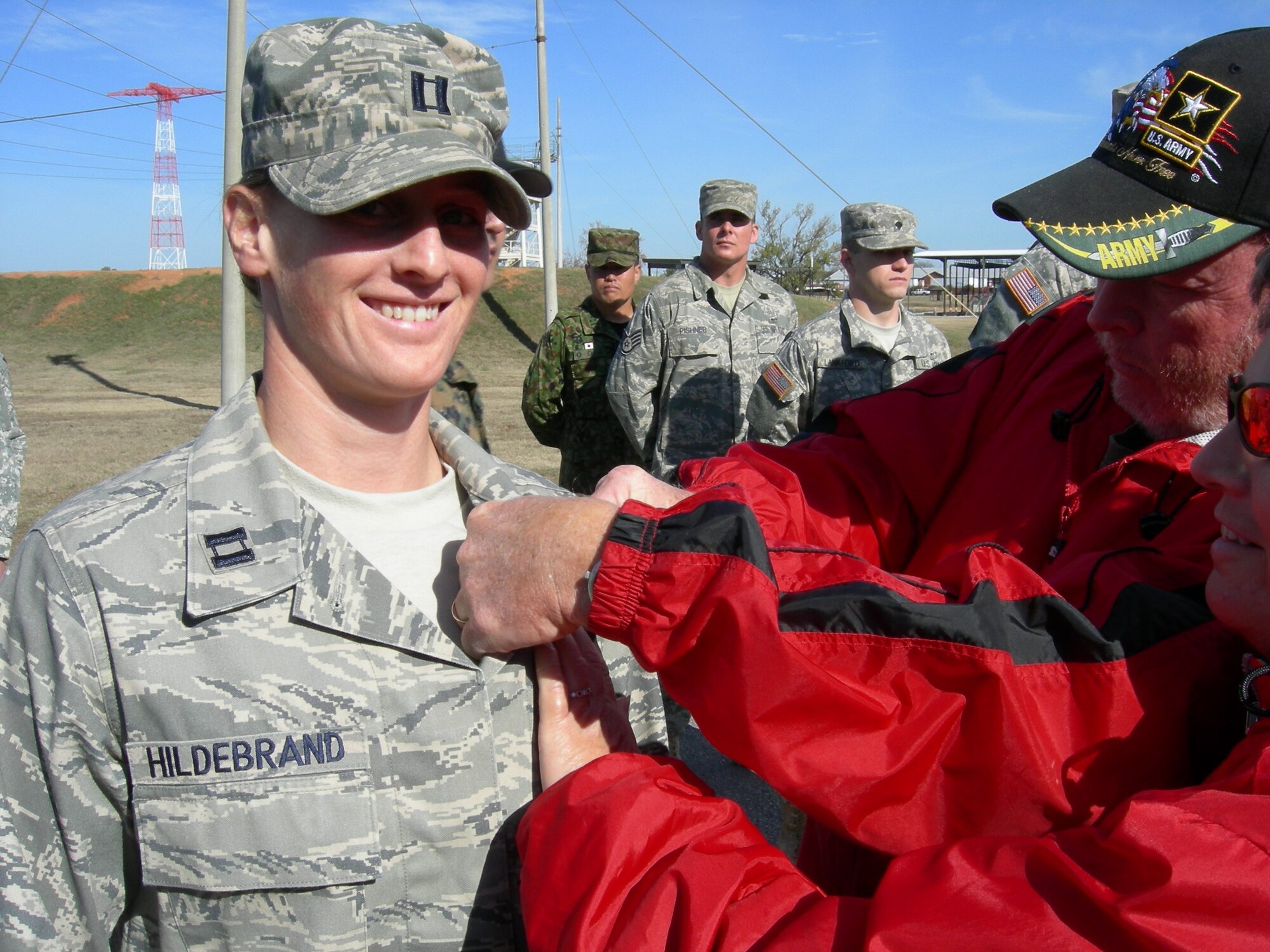 Capt. Dawn Hildebrand has her newly-earned airborne jump wings pinned to her chest by her parents, Mark and Denise Hildebrand, in a ceremony at Fort Benning, Ga. Dec. 3.  Captain Hildebrand is an Air Mobility Liaison Officer assigned the 621st Contingency Response Wing at Joint Base McGuire-Dix-Lakehurst and is attached to the 82nd Airborne Division at Fort Bragg, NC. (courtesy photo)