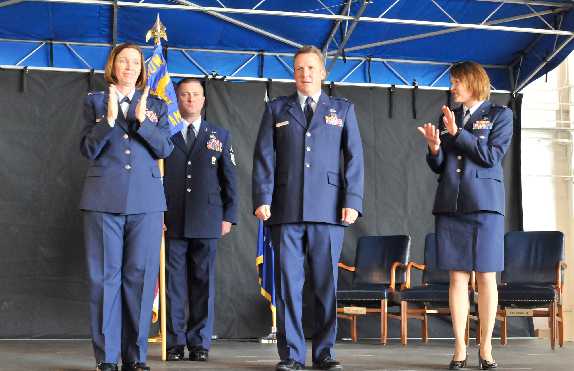 PATRICK AIR FORCE BASE, Fla. - Col. Charlene Nelson, Commander of the 920th Rescue Wing Maintenance Squadron, claps at the end of the Change of Command Ceremony where Lt. Col. David Cooksey assumed command of the 920th Aircraft Maintenance Squadron from Maj. Jennifer West, on the far right, here December 5.  An Operation Desert Storm and Shield veteran, Lieutenant Colonel Cooksey was born in Jacksonville and entered the Air Force in 1985 receiving his commission four years later though the U.S. Air Force Academy, Colorado Springs, Col.  The 920th RQW is an Air Force Reserve unit which performs more than 20 percent of the Air Force's combat search and rescue missions. The Wing is comprised of 1,500 Airmen and flies both fixed and rotor wing aircraft: the HC-130P/N extended-range Hercules and the HH-60G Pave Hawk helicopter. (U.S. Air Force photo/Capt. Ryan Liss)