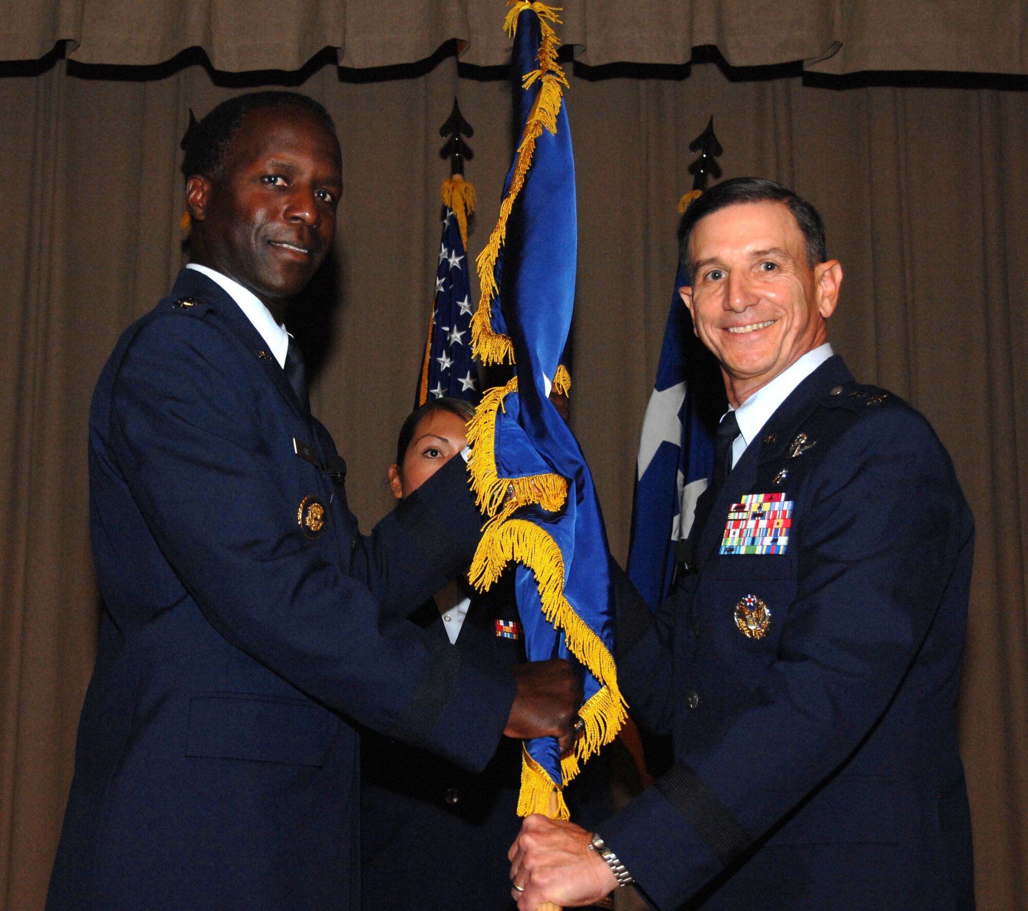 Maj. Gen. (Dr.) Byron Hepburn, 59th Medical Wing commander (right), accepts his two-star flag from Gen. Edward Rice Jr., commander, Air Education and Training Command, during his promotion ceremony at Wilford Hall Medical Center, Lackland Air Force Base, Texas, Dec. 3. (U.S. Air Force photo by Staff Sgt. Robert Barnett)