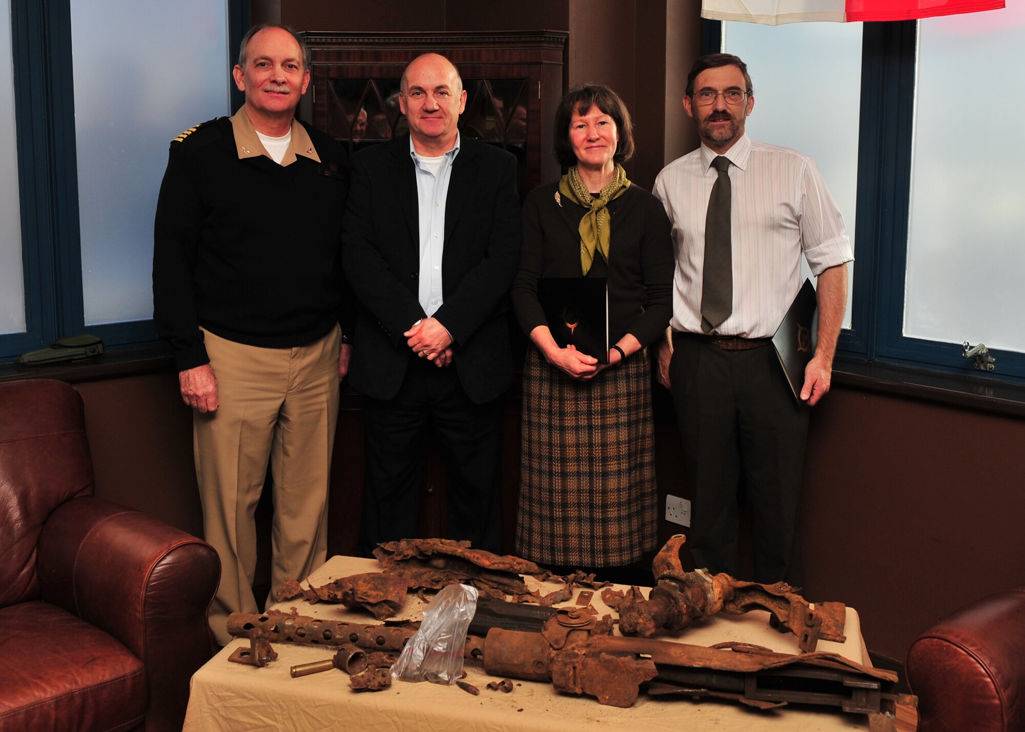Kevin and Carole Ryder at Royal Air Force Molesworth on 3 December 2010 with JIOCEUR Analytic Center Deputy Commander U. S. Navy Captain Gary S. Powers, and Mr. Chris Knapp Conservationist from the Imperial War Museum Duxford.  Mr. Knapp is advising on pre-display conservation of the machine gun from the B-17G Flying Fortress of the 2LT George A. Kyle crew. U.S. Air Force photo by Staff Sgt. Javier Cruz