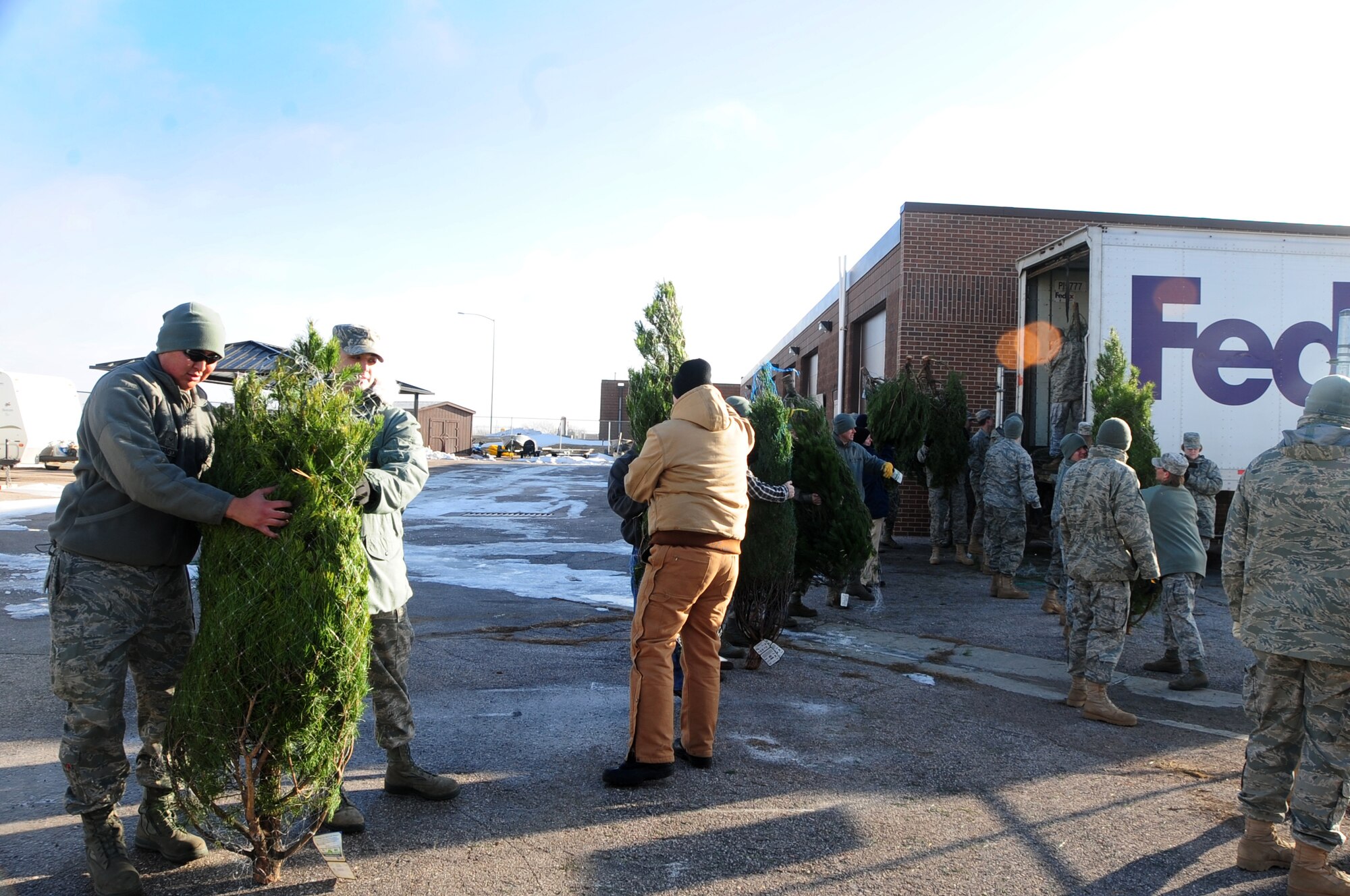 ELLSWORTH AIR FORCE BASE, S.D. -- Ellsworth Airmen and civilians work together to unload 300 Christmas trees for the "Trees for Airmen" program, Dec. 3.  The nationwide program delivers free Christmas trees to Airmen and their families for the holidays. (U.S. Air Force photo/Senior Airman Anthony Sanchelli)
