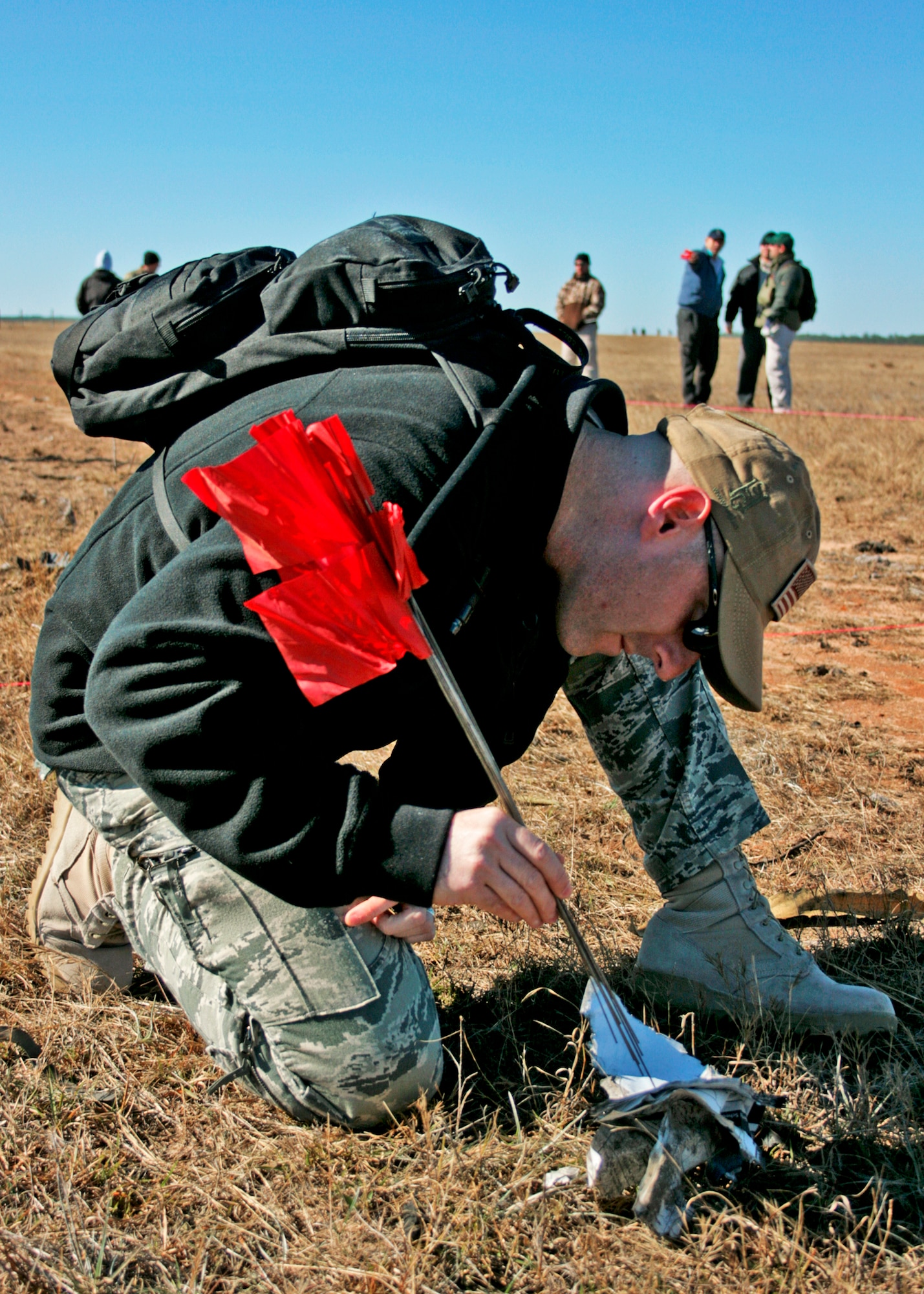 Tech. Sgt. James Fleming, 1st Special Operations Civil Engineer Squadron, discovers a key piece of evidence during the investigation of a created crime scene Dec. 1 at Eglin Air Force Base, Fla.  The investigations were part of the FBI's large vehicle post blast school attended by state and local law enforcement agencies as well as Marine and Air Force explosive ordnance disposal technicians. Three vehicles were blown up to create the crime scenes that students would investigate.  The class was the largest class held in the U.S. and the first ever here. (U.S. Air Force photo/ 2nd Lt. Andrew Caulk)