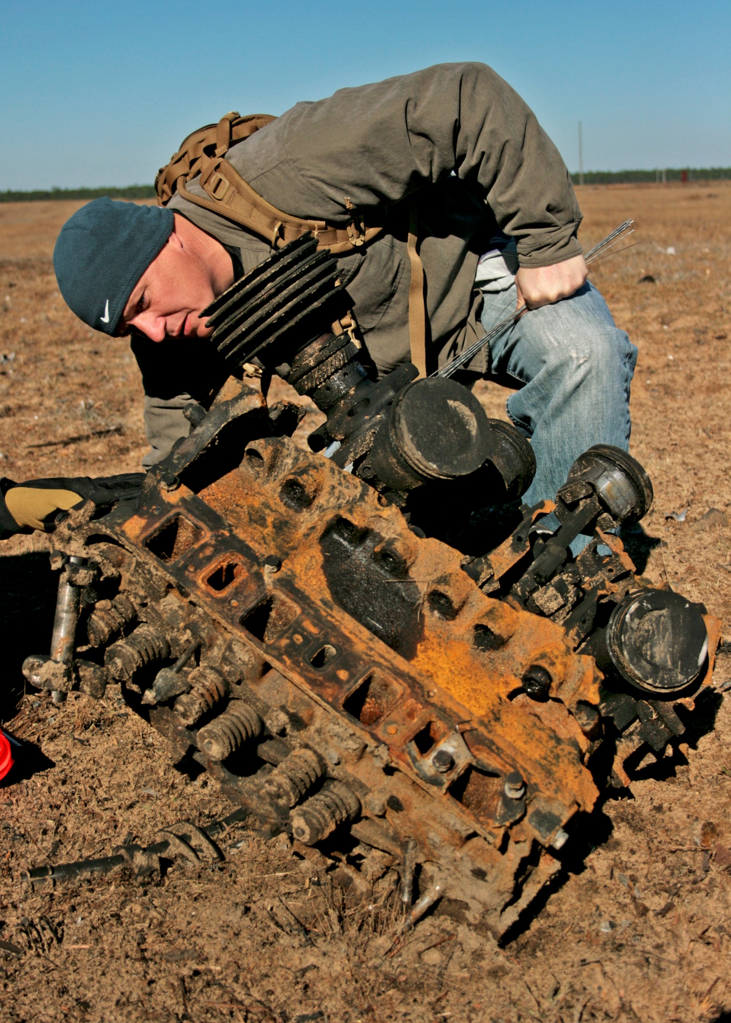Gunnery Sgt. Hugh McClenney, explosive ordnance disposal technician at Marine Air Station Cherry Point, N.C., examines the scorched engine block of a box truck while investigating the created crime scene Dec. 1 at Eglin Air Force Base, Fla. The investigations were part of the FBI's large vehicle post blast school attended by state and local law enforcement agencies as well as Marine and Air Force EOD technicians. Three vehicles were blown up to create the crime scenes that students would investigate.  This was the largest class held in the U.S. and the first ever here. (U.S. Air Force photo/ 2nd Lt. Andrew Caulk)