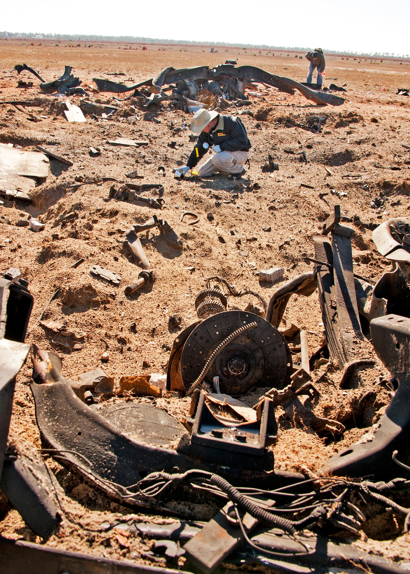 Davis Blanchard, Florida Department of Law Enforcement, collects soil samples from the explosion crater during the preliminary investigation of a created crime scene Dec. 1 at Eglin Air Force Base, Fla.  The investigations were part of the FBI's large vehicle post blast school attended by state and local law enforcement agencies as well as Marine and Air Force explosive ordnance disposal technicians. Three vehicles were blown up to create the crime scenes that students would investigate.  This was the largest class held in the U.S. and the first ever here. (US Air Force photo/ Samuel King)