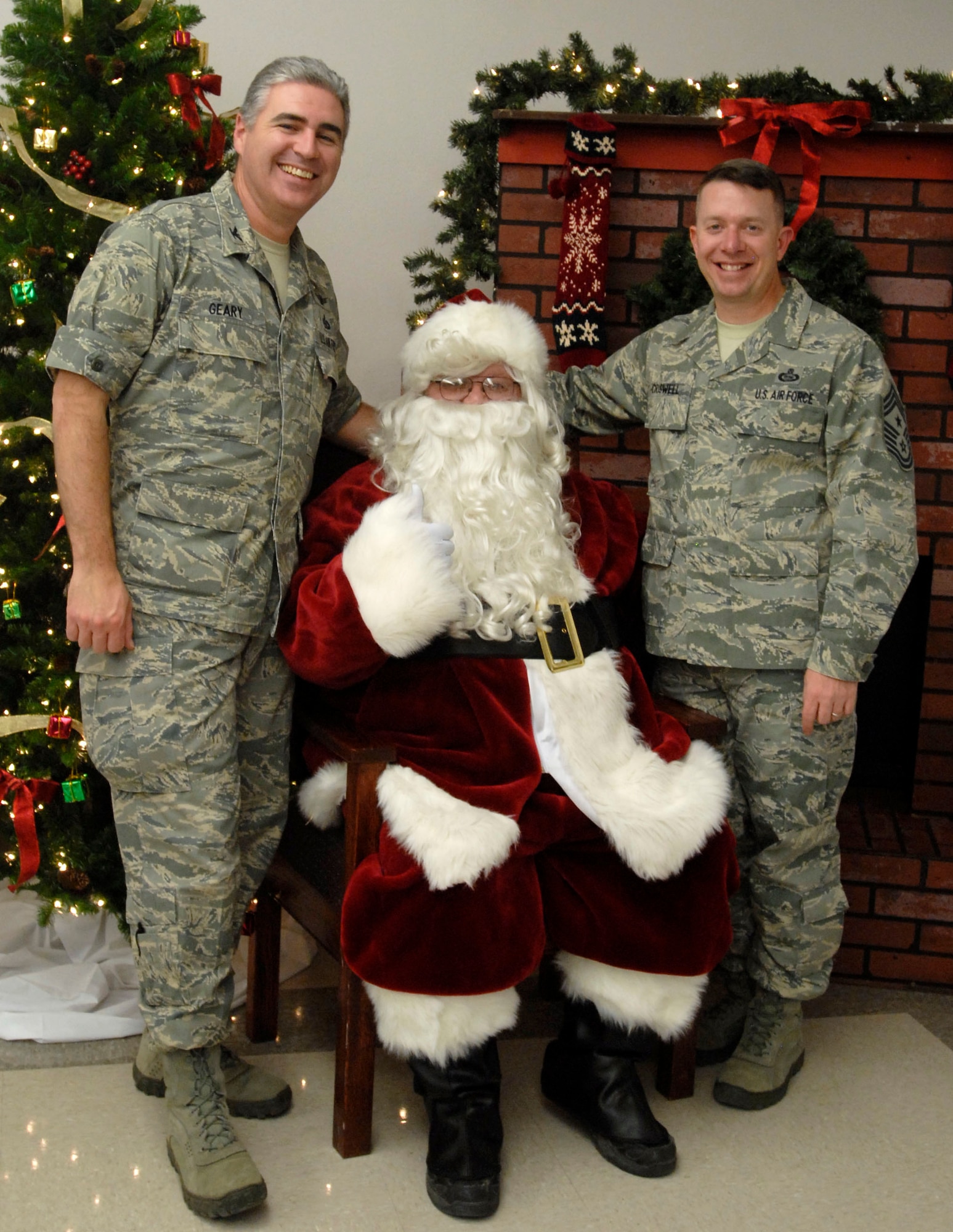 GOODFELLOW AIR FORCE BASE, Texas-- Col. Thomas Geary, 17th Training Wing Commander and Chief Master Sgt.  Brendan Criswell, 17th TRW Command Chief, take a moment to speak with Santa after the annual Goodfellow Tree Lighting Ceremony held Dec. 1 at the Base Chapel. The ceremony celebrated the beginning of the holiday season. (U.S. Air Force photo/Airman 1st Class Jessica D. Keith)