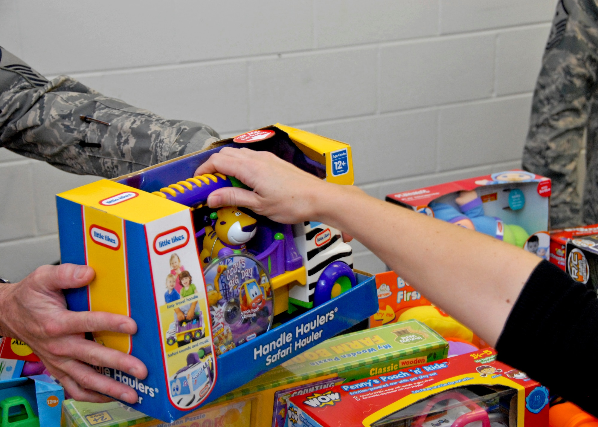 Parents rummaged through the piles of toys, puzzles, baby dolls and games to find the perfect gift for a special child at the toy distribution at the Airman's Attic Dec. 2. Over 2,400 toys  were given out to 502 children. (U.S. Air Force photo/Sachel Seabrook)

