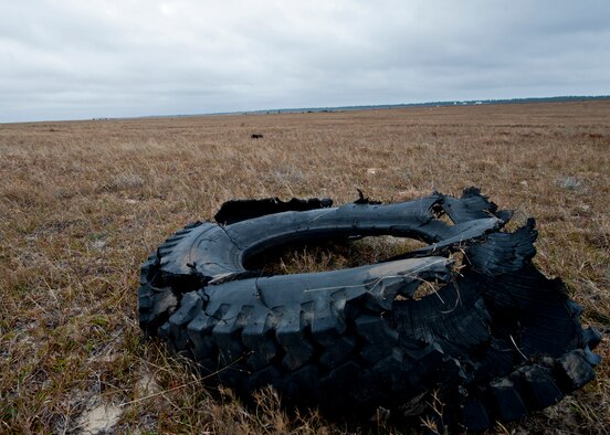 The left front tire of a box truck was blasted a distance of 820 feet when the vehicle was detonated Nov. 30 on Eglin Air Force Base's range.  The detonation created a crime scene for the FBI's large vehicle post blast school.  State and local law enforcement agencies as well as Marine and Air Force explosive ordnance disposal technicians attended the week-long class.  Students formed teams and investigated the simulated crime scene to determine what happened and create a case.  (U.S. Air Force photo/ Samuel King)