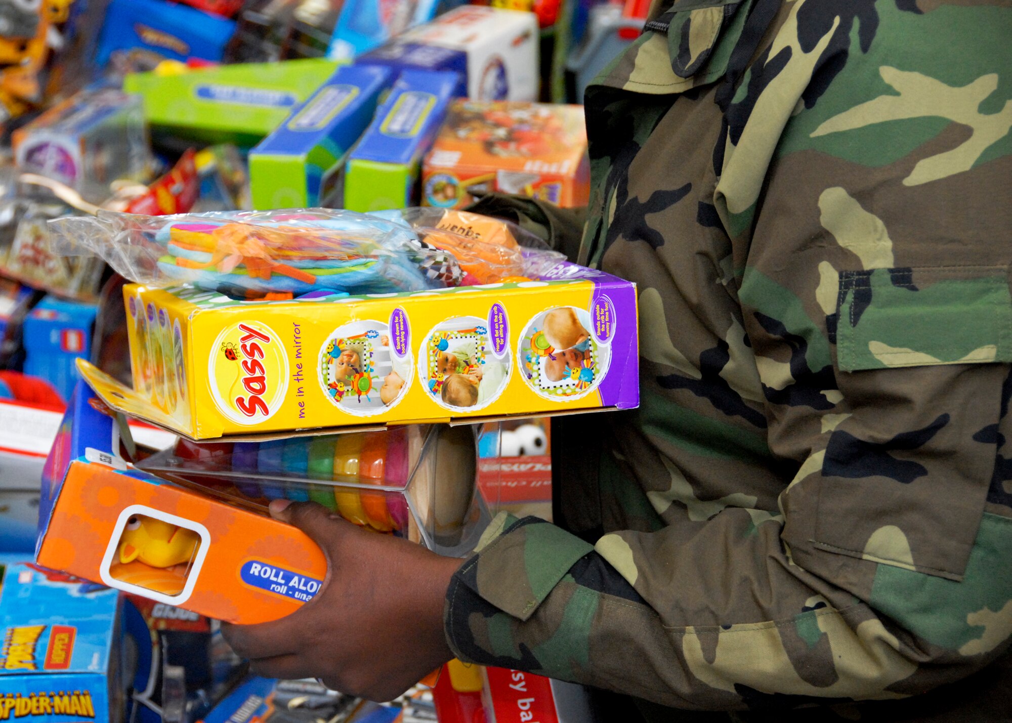Parents rummaged through the piles of toys, puzzles, baby dolls and games to find the perfect gift for a special child at the toy distribution at the Airman's Attic Dec. 2. Over 2,400 toys  were given out to 502 children. (U.S. Air Force photo/Sachel Seabrook)

