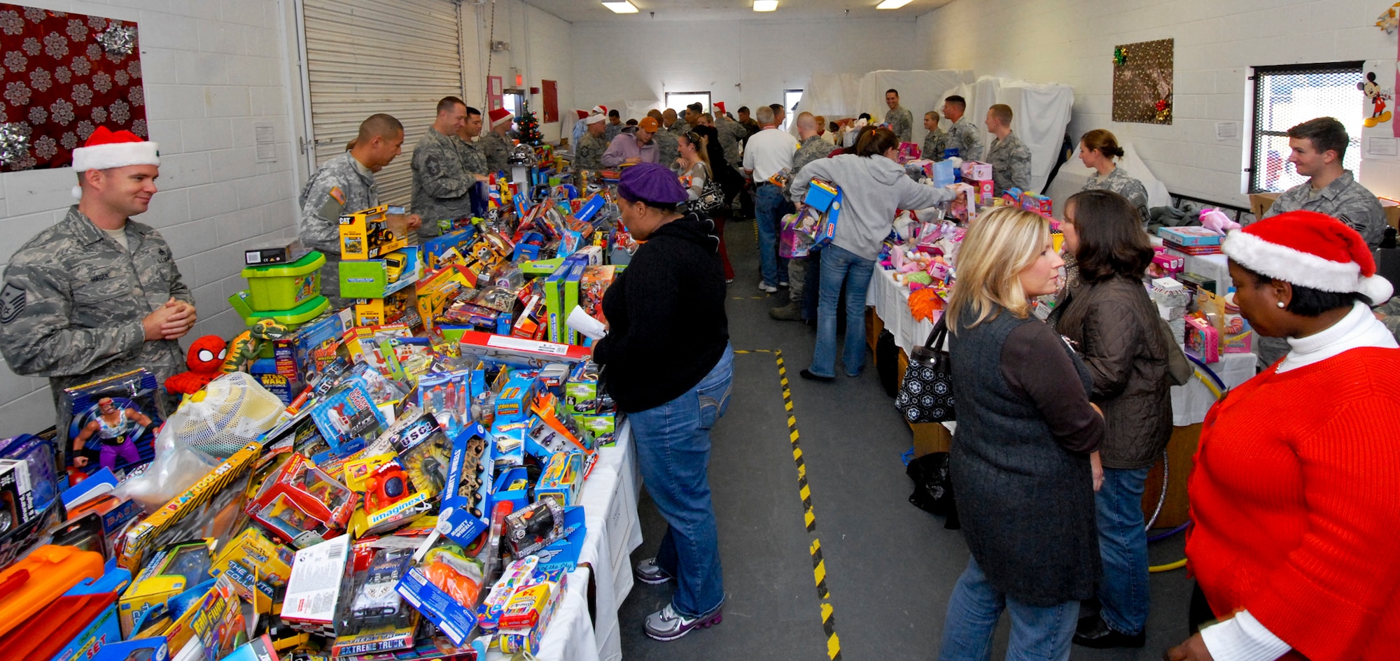 Volunteers became Santa's elves and helped deserving Airmen pick out the perfect gift for their children during the toy distribution at the Airman's Attic Dec. 2. Over 2,400 toys  were given out to 502 children. (U.S. Air Force photo/Sachel Seabrook)