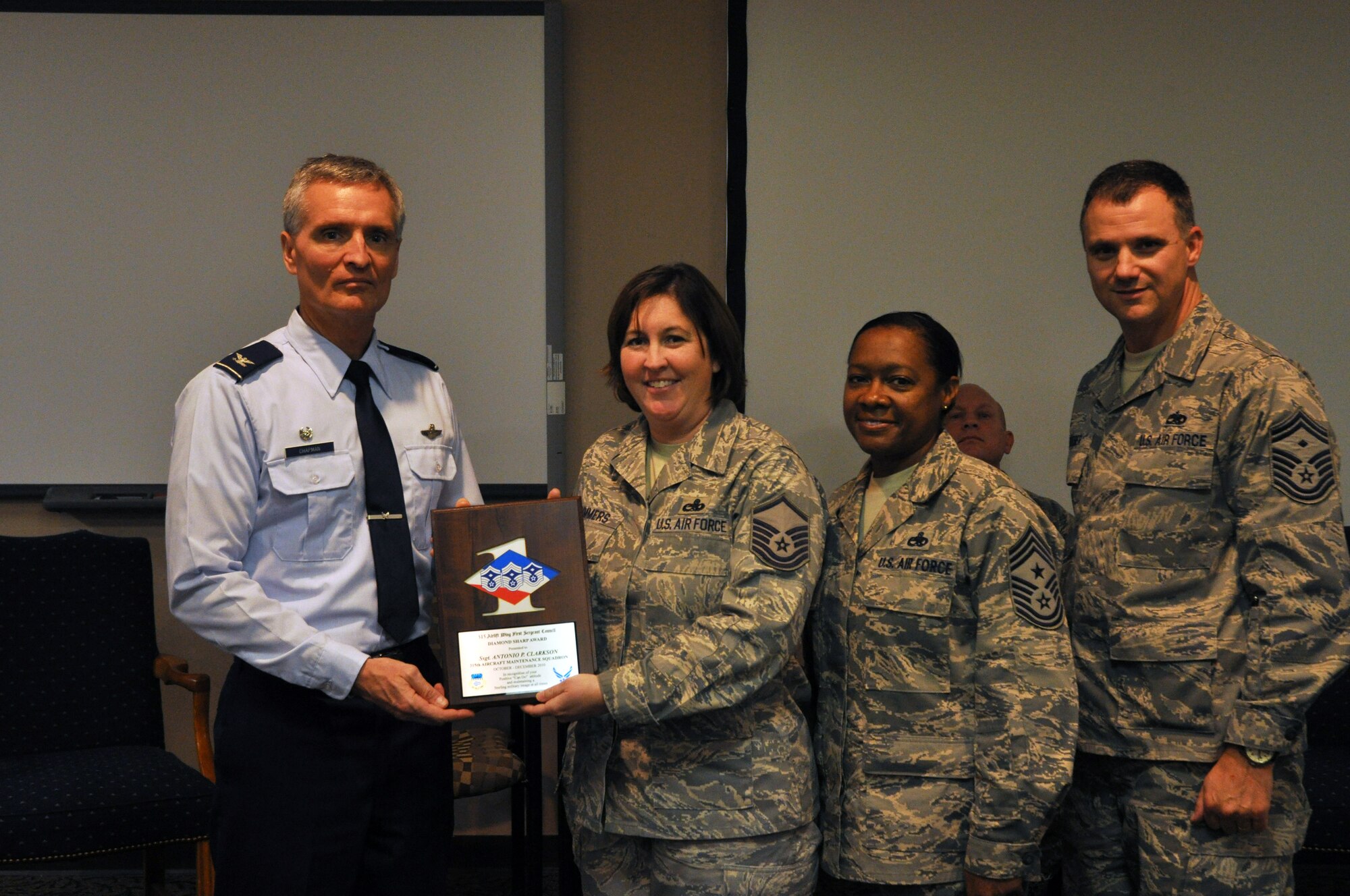 Master Seargant Michele Summers, 315th Maintinance Squadron Charleston AFB SC accepts the diamond sharp award on behalf of Staff Sergeant Antonio Clarkson December 5. The award goes to airman who demonstrate the Air Force core values at work and through their volunteer efforts in the community. (U.S. Air Force Photo/ TSgt Scott Mathews)