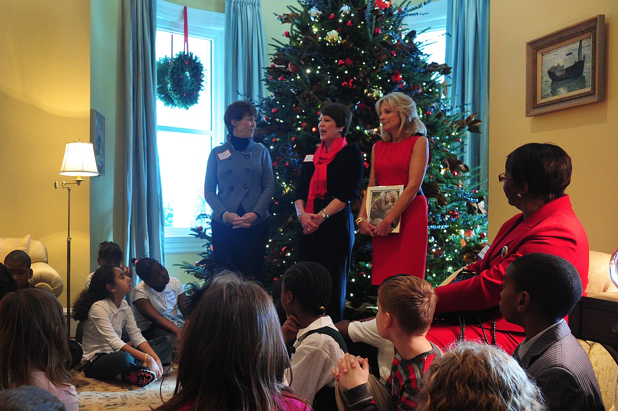 Cheryl McKinley, center, wife of Air Force Gen. Craig McKinley, chief of the National Guard Bureau, talks to children of National Guard families invited to take part in a holiday tree trimming event at the official residence of the vice president, Dec. 1, 2010. During the event, children made cards for service members and ornaments that will be on display at the residence throughout the holiday season. Standing with McKinley are Dr. Jill Biden, right, wife of Vice President Joe Biden, and Shelia Casey, left, wife of Army Gen. George Casey, the Army chief of staff. (U.S. Army photo by Sgt. 1st Class Jon Soucy)(Released)