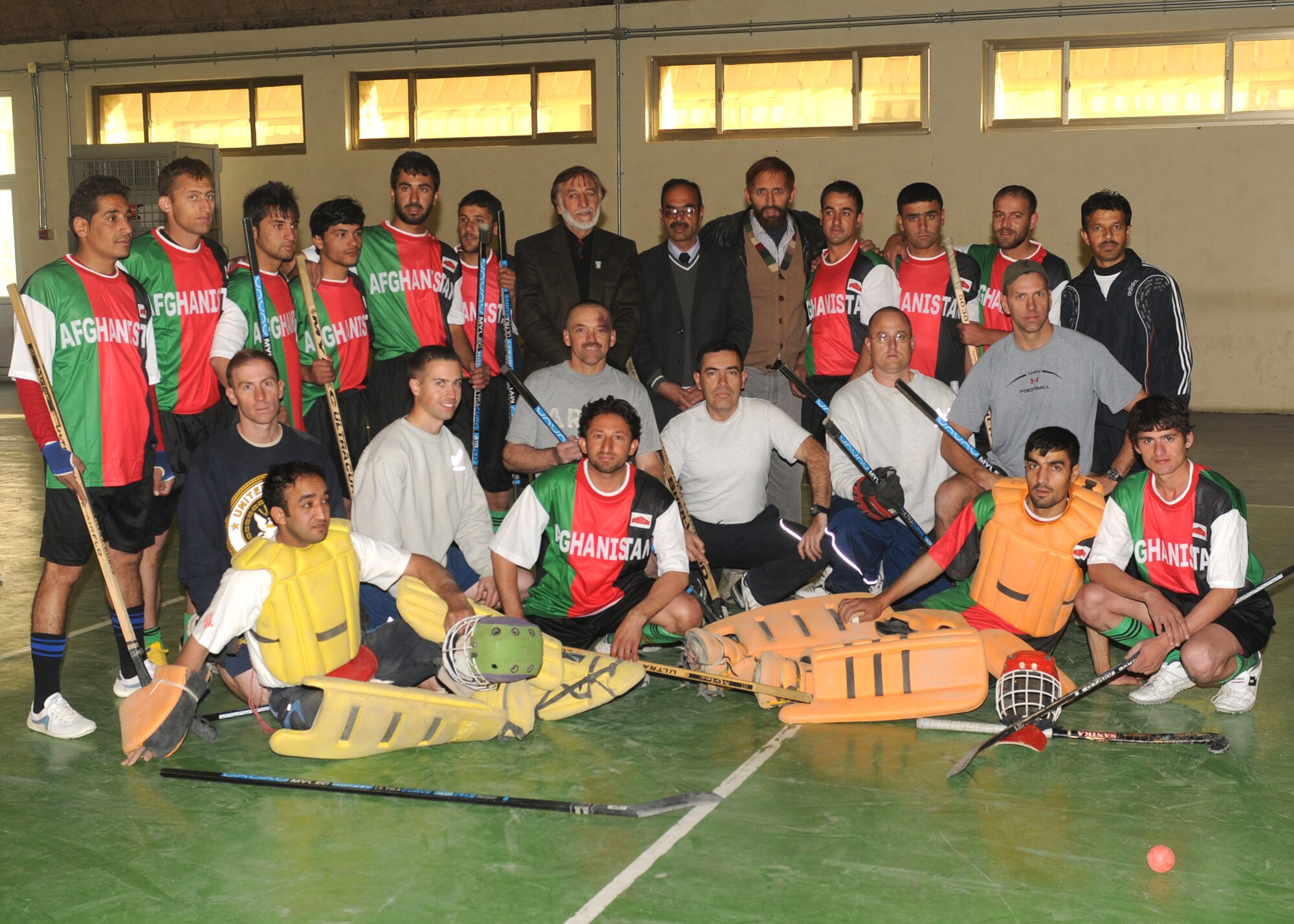 KABUL, AfghanistanThe Kabul International Airport NATO hockey team and the Nuristan provincial field hockey team pose for a group photo at the gymnasium at the Afghan Air Force Base in Kabul, Afghanistan Dec.5. The two teams took part in a friendly exhibition mixing floor and field hockey, with the team from Nuristan coming out on top by a score of 9-3. (Photo by MC2 Vladimir Potapenko/RELEASED)