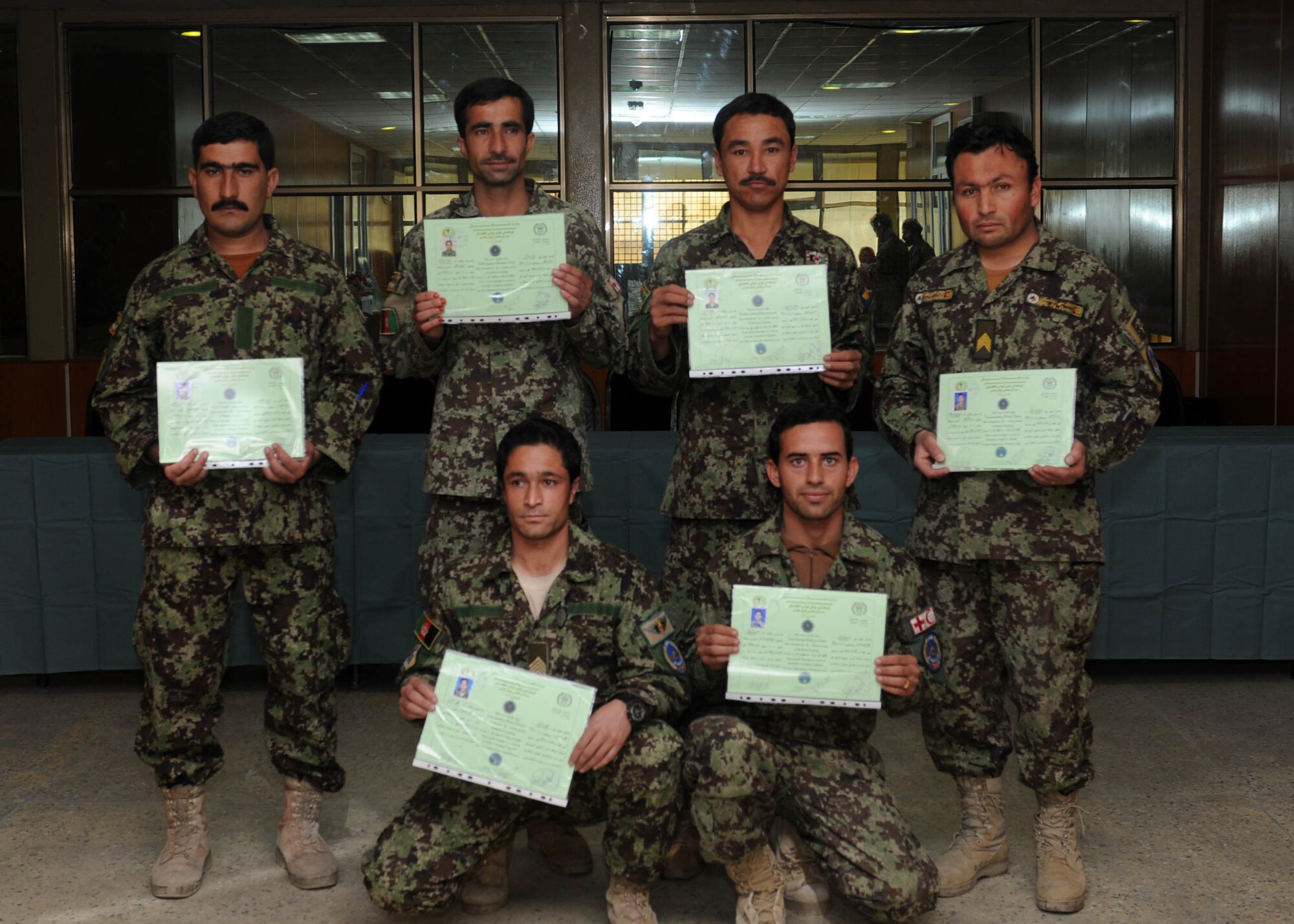 101206-N-6541W-022 KABUL, Afghanistan - Seven newly graduated flight medics pose for a photo after graduating from the flight medic course at the Afghan Air Force Base on Kabul International Airport, Dec. 6. This is the first medical course to be instructed by an Afghan Air Force flight medic instructor.  (U.S. Navy photo by Mass Communication Specialist 3rd Class Jared Walker/ RELEASED).