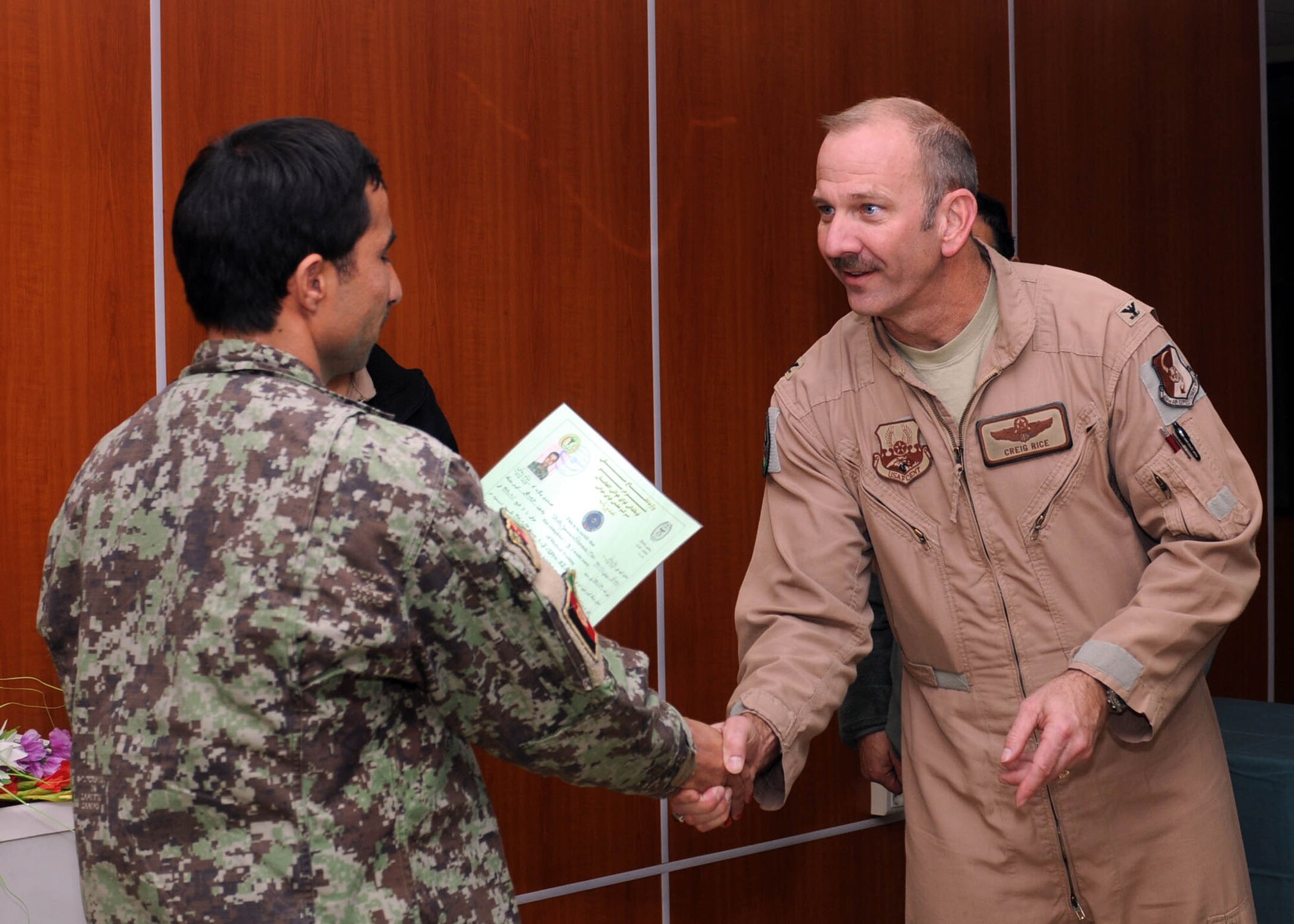 101206-N-6541W-006 KABUL, Afghanistan - Col. Creig A. Rice, Vice Commander of the 438th Air Expeditionary Wing/NATO Air Training Command - Afghanistan presents a certificate to a newly graduated flight medics in the Afghan Air Force at Afghan Air Force Base on Kabul International Airport, Dec. 6. This is the first medical course to be instructed by an Afghan Air Force flight medic instructor.  (U.S. Navy photo by Mass Communication Specialist 3rd Class Jared Walker/ RELEASED).