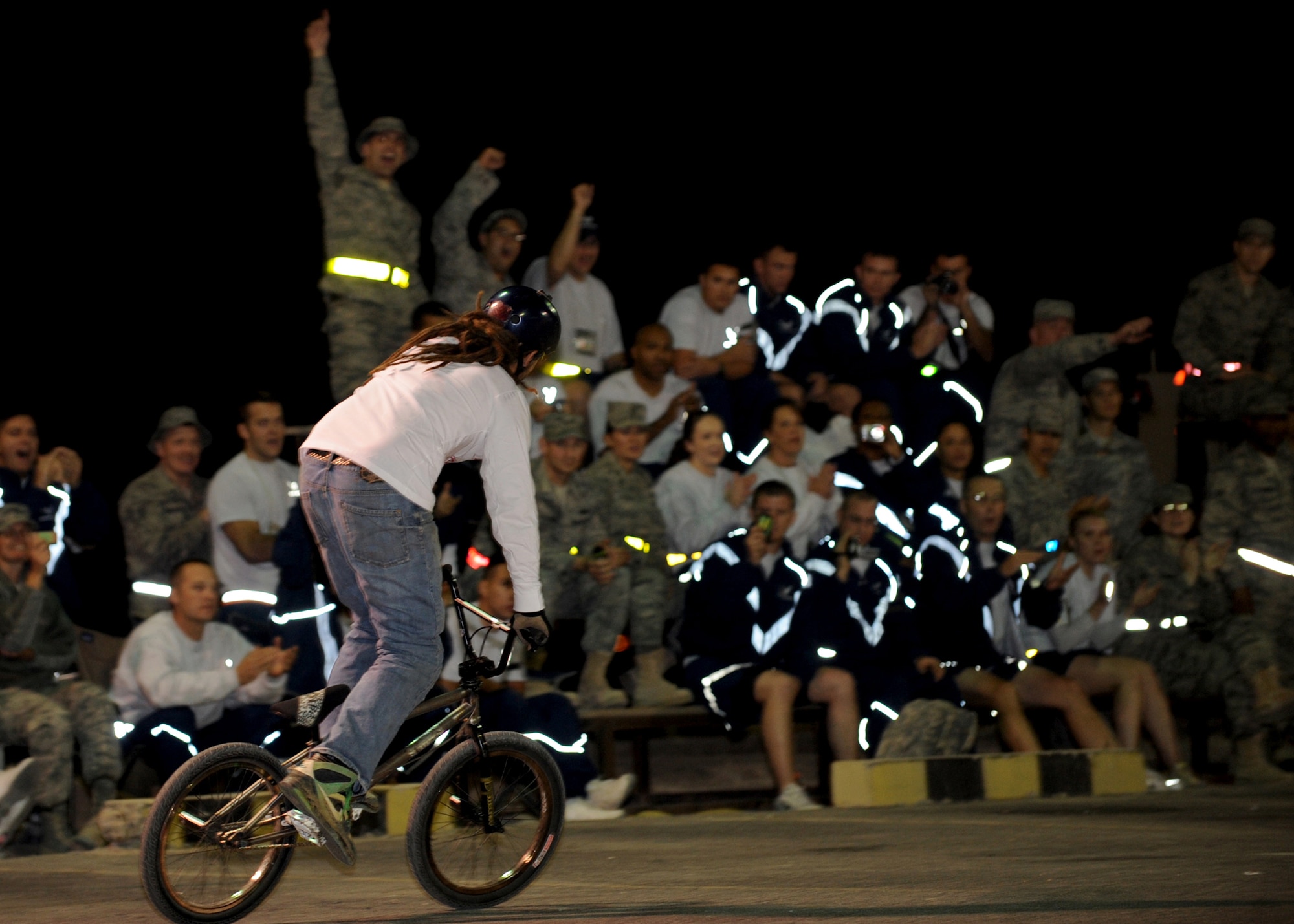 SOUTHWEST ASIA -- A rider from the Bikes Over Baghdad bicycle motocross team hypes a crowd of Airmen from the 386th Air Expeditionary Wing during a demonstration at an undisclosed air base here Nov. 30, 2010. BOB is performing at seven military bases as part of its current tour, riding for an estimated 20,000 deployed U.S. military members on ramps built by BMX contractors Nate Wessel and Ron Kimler, who also accompany the team. (U.S. Air Force photo by Senior Airman Laura Turner)