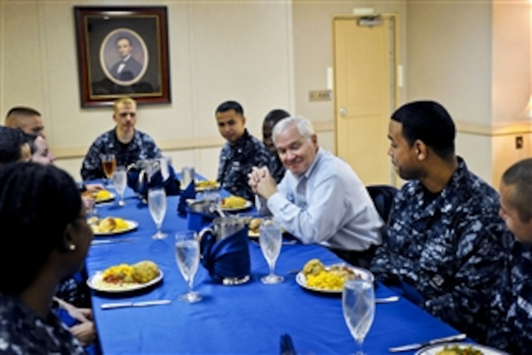 U.S. Defense Secretary Robert M. Gates talks with sailors during lunch aboard the aircraft carrier USS Abraham Lincoln in the Arabian Sea, Dec. 6, 2010. The Abraham Lincoln Carrier Strike Group is supporting maritime security operations and theater security cooperation efforts to establish conditions for regional stability.