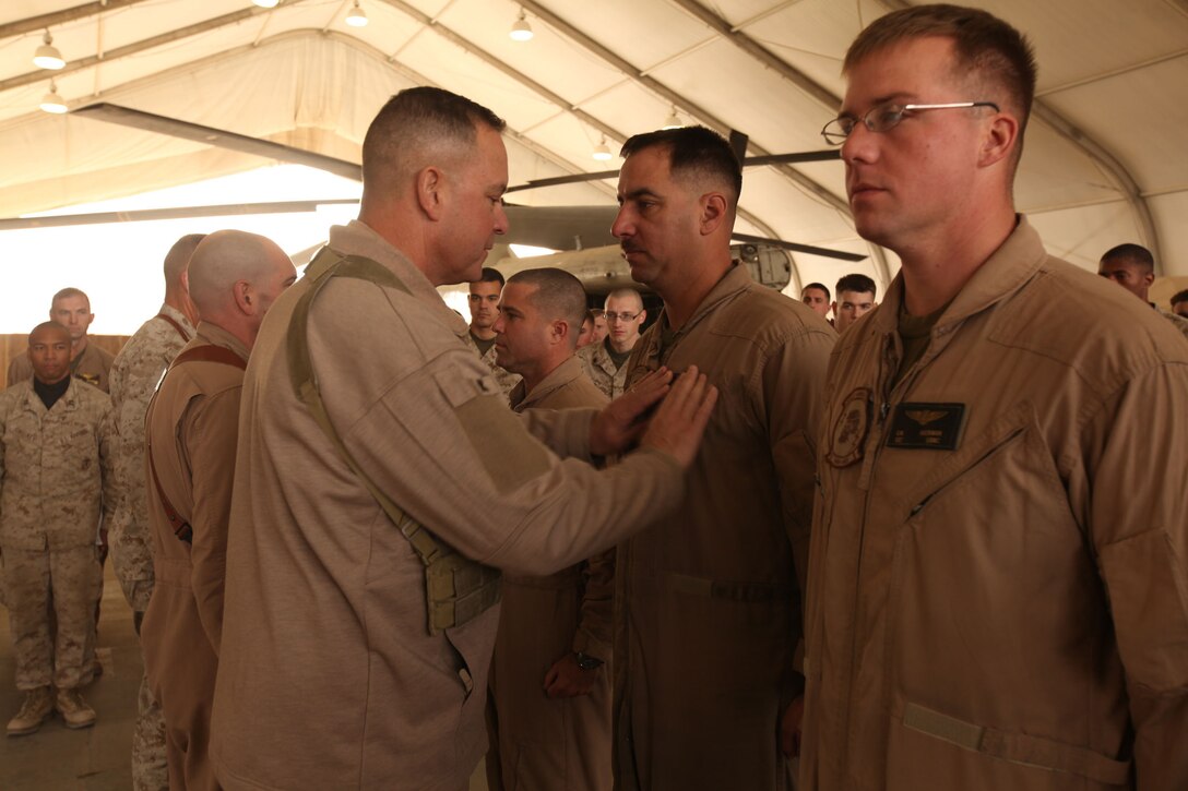 Brig. Gen. Andrew W. O'Donnell Jr., the 3rd Marine Aircraft Wing (Forward) commanding general, places a new patch with the combat aircrew wings on Gunnery Sgt. John Delgado, an aerial observer with Marine Heavy Helicopter Squadron 362, 3rd MAW (Fwd), at the flightline aboard Camp Bastion, Afghanistan, Dec. 6.  Delgado and four other HMH-362 Marines received their combat aircrew wings for flight time during a deployment.  It is a prestigious distinguishing device as it is symbolic of Marine aviation’s deep bond and commitment to supporting the infantry and coalition forces in Afghanistan.